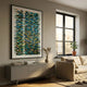 Timewave Vibrant Geometric Patterned Enamel Wall Art by Giant Sculptures, blue, green, yellow and brown strips on white, hung above a grey sideboard beside a window.