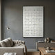 Luneve Gold Leaf 3D Ceramic Wall Art by Giant Sculptures displayed on a grey wall above a beige sofa and console in a modern living room.