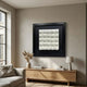 Harmonia 3D Ceramic Floral Wall Sculpture by Giant Sculptures, white ceramic blooms in a grid on black ground, displayed above a wooden console in a living room.