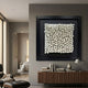 Harmonia 3D Ceramic Grid Wall Sculpture by Giant Sculptures with white rods in a black frame, mounted above a wood sideboard in a modern living space.