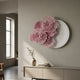 Fleur Halo White Round Pink Metal Floral Decorative Wall Art by Giant Sculptures displayed above a beige console with vase in a soft grey interior.