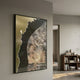 Astrid Gold Edge Earthy Abstract Wall Art by Giant Sculptures, framed in black with cream, grey, and gold textured composition, hung in a neutral living space beside a walnut bookshelf.