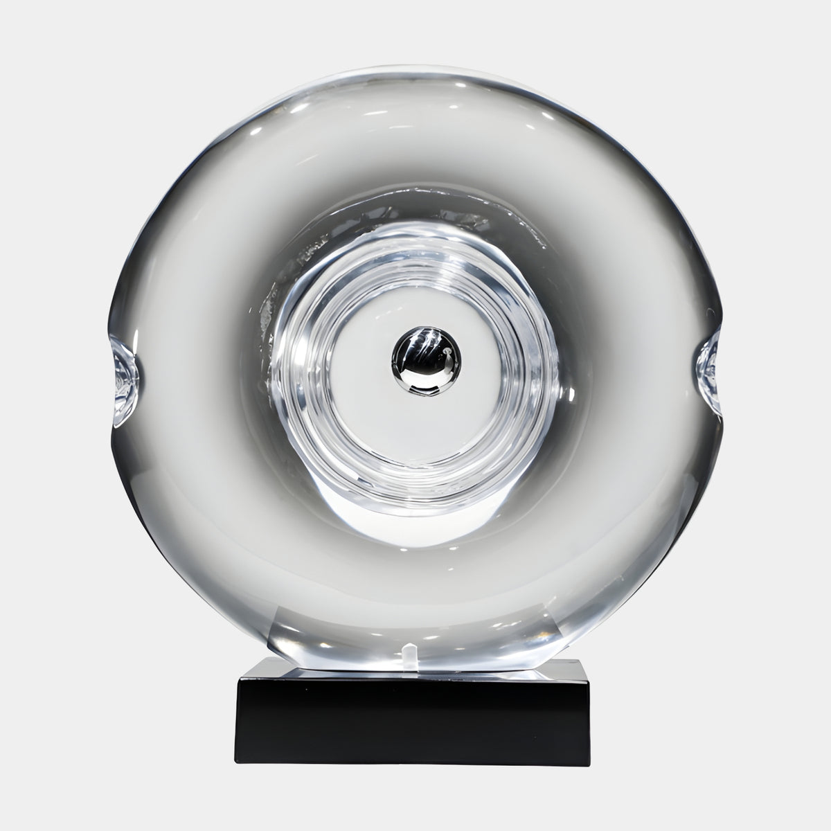 Clear Turned Ring Disc on Marble Resin Sculpture, 63cm, with concentric rings and a dark centre bead on a black marble base, plain white background.