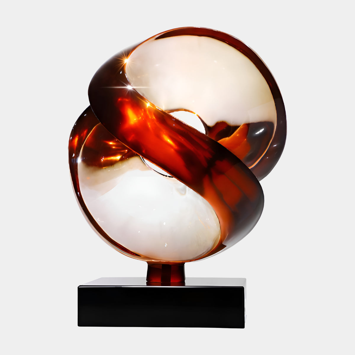 White & Red Cut Sphere on Marble Resin Sculpture - 46cm, interlocking scooped forms in white with a red ribbon band, on a black marble base, plain white background.