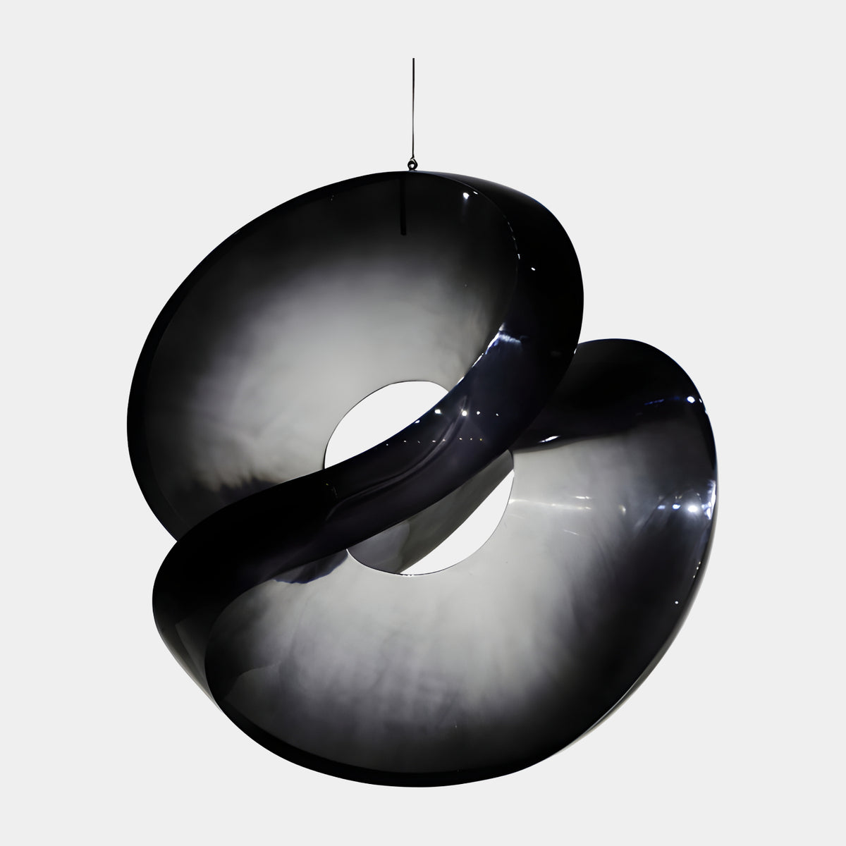 Smoked Black Double Loop Hanging Resin Sculpture (82cm) by Giant Sculptures, a twisted band with cupped curves fading from black to translucent grey, suspended against a plain white background.