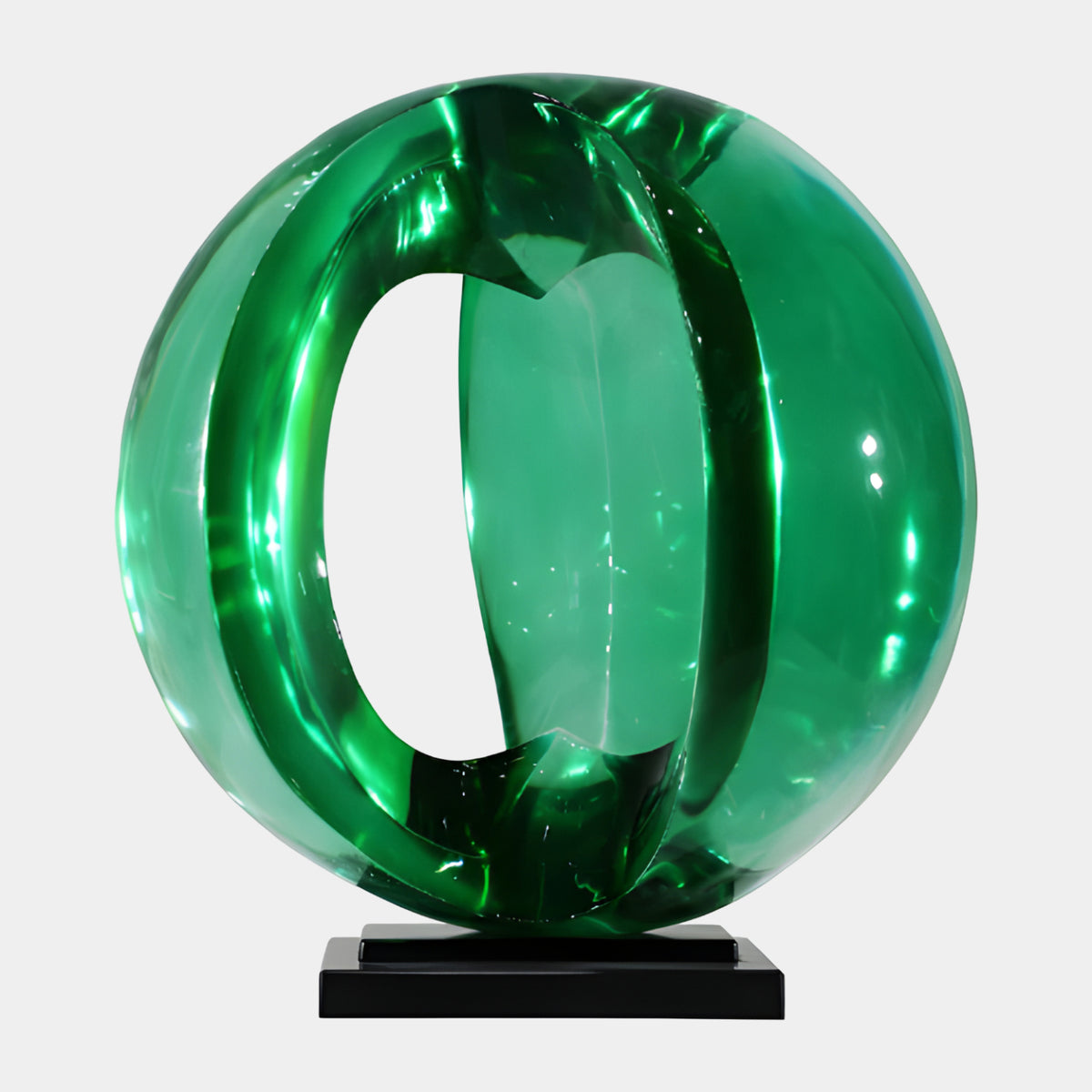 Green Slotted Sphere on Black Plates Resin Sculpture - 63cm, a glossy green resin sphere cut through the middle, set on a stacked black base, shown against a plain white background.