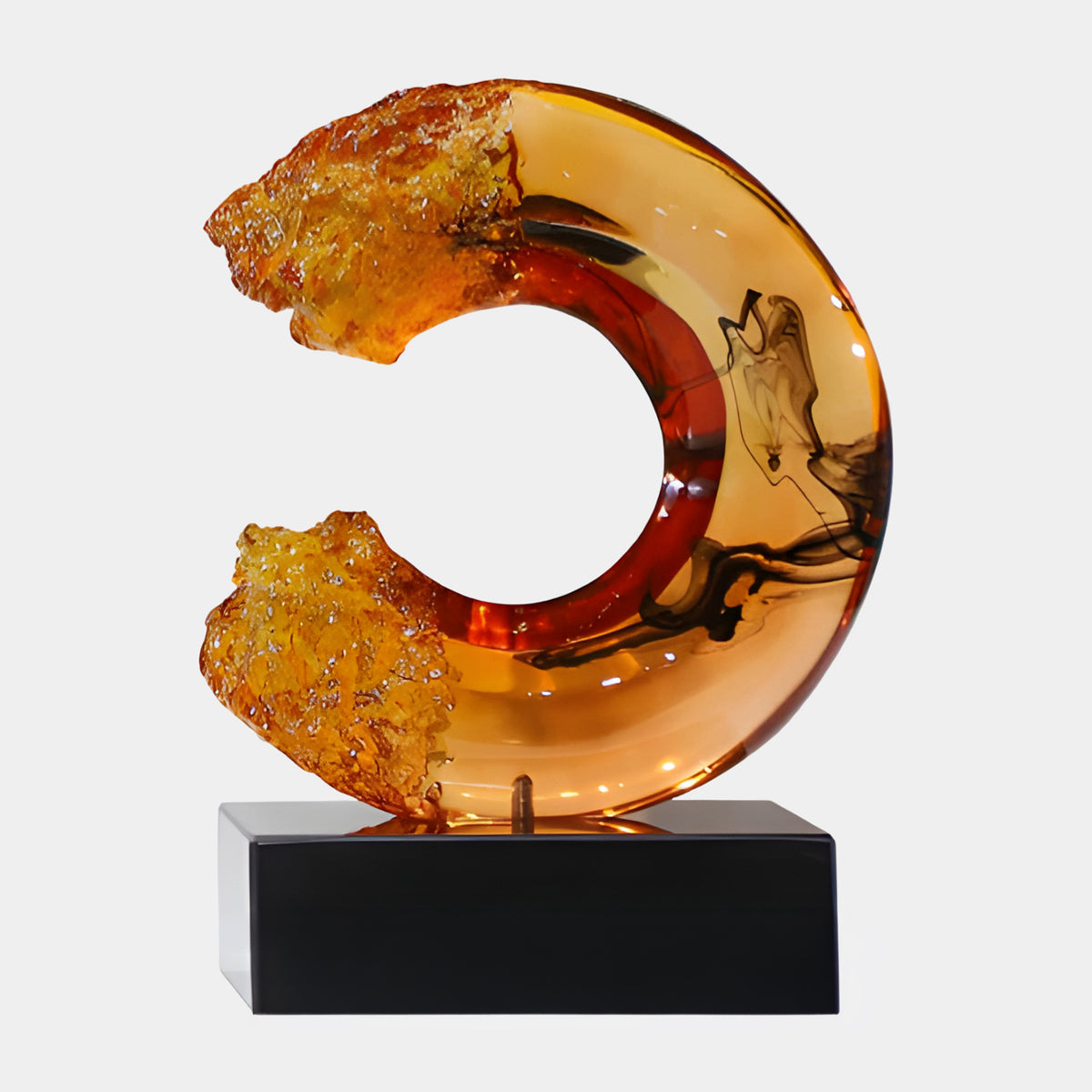 Amber Inked Broken Ring on Marble Resin Sculpture, 32cm, with black ink swirls and frosted amber ends, set on a black marble base against a plain white background.