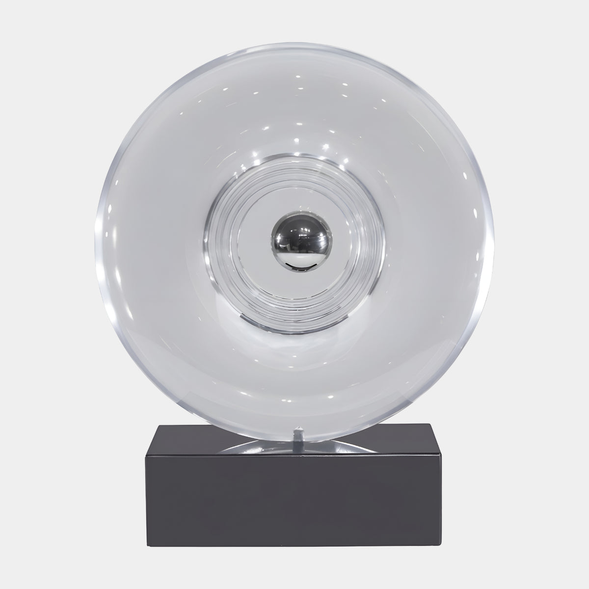 Clear Dished Disc with Mirrored Bead Resin Sculpture (43cm) by Giant Sculptures, showing a transparent dished disc with a silver bead center on a black marble base, set against a plain white background.