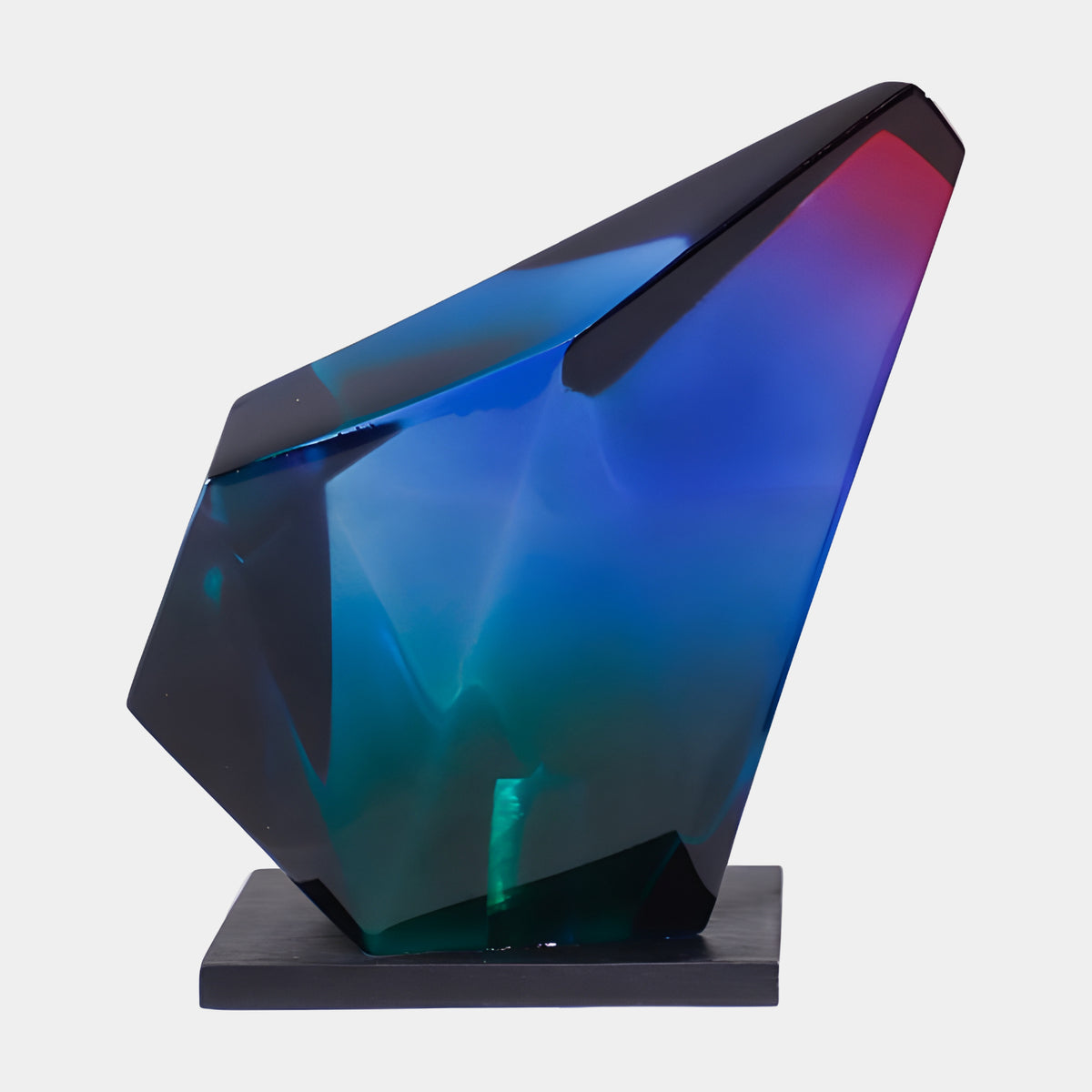 Multi-Colour Faceted Gem Block Resin Sculpture, 22cm, with sharp angular planes graded blue, green and magenta, on a black wood base against a plain white background.