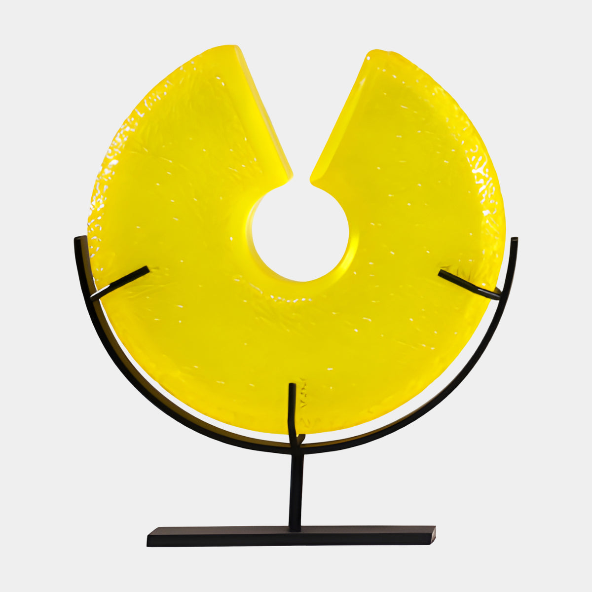 Yellow Slit Disc in a Metal Cradle Resin Sculpture, 33cm, glossy textured resin disc with a central hole on a black metal stand, plain white background.