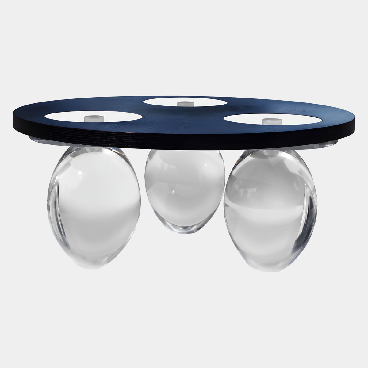 Black Timber Disc Acrylic Low Table on Three Ovoids, 90cm, a near-black wood disc with cutouts resting on clear acrylic egg forms, shown on a plain white background.