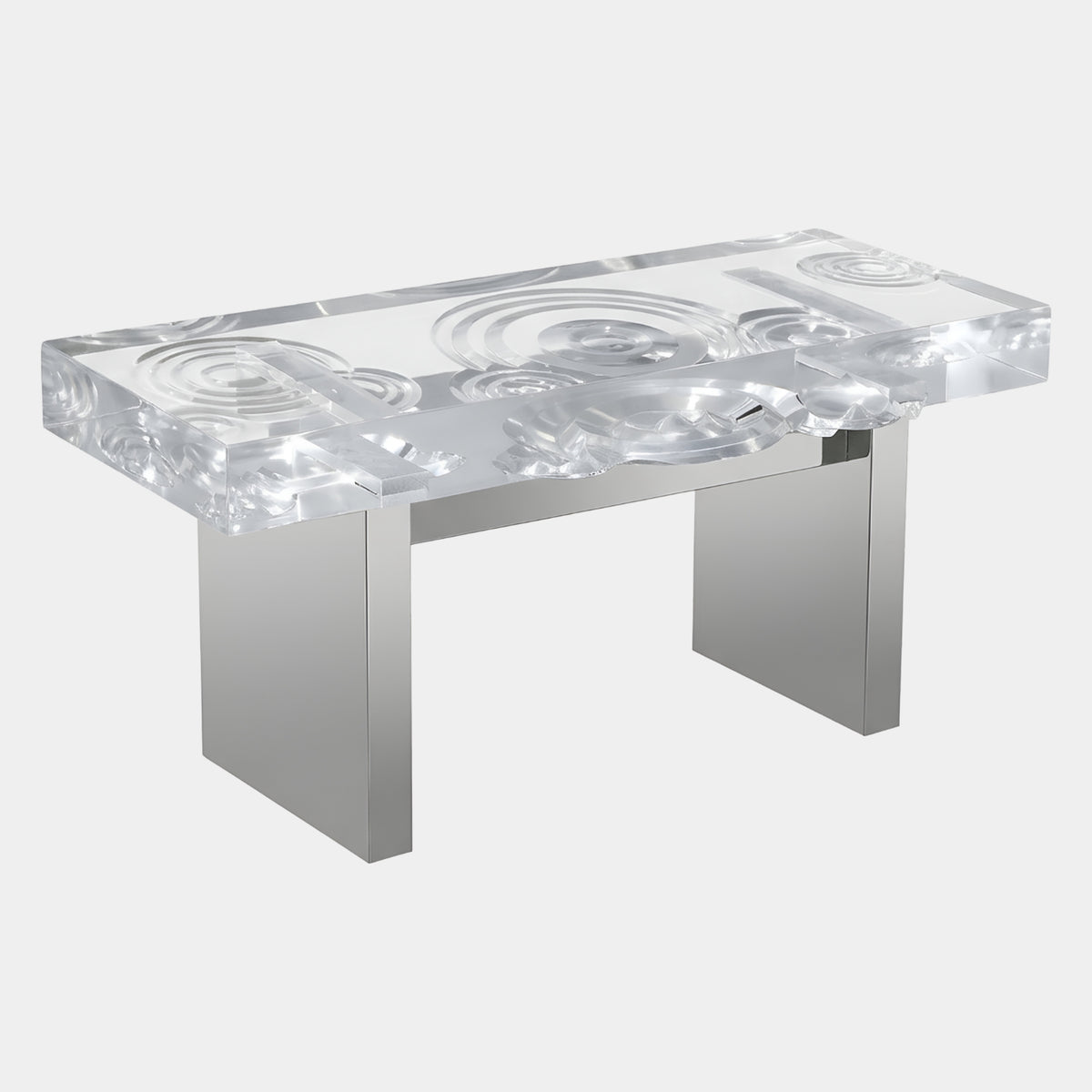 Clear Ring-Carved Acrylic Bench on Polished Blades, 120cm, with concentric ring carvings on the acrylic top and stainless steel blade legs, shown on a white background.