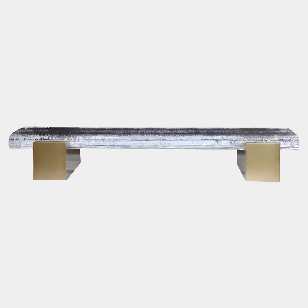 Clear Textured Panel Lit Bench on Brass Blocks - 150cm by Giant Sculptures, a low textured acrylic seat glowing from below, resting on two brass block supports against a plain white background.