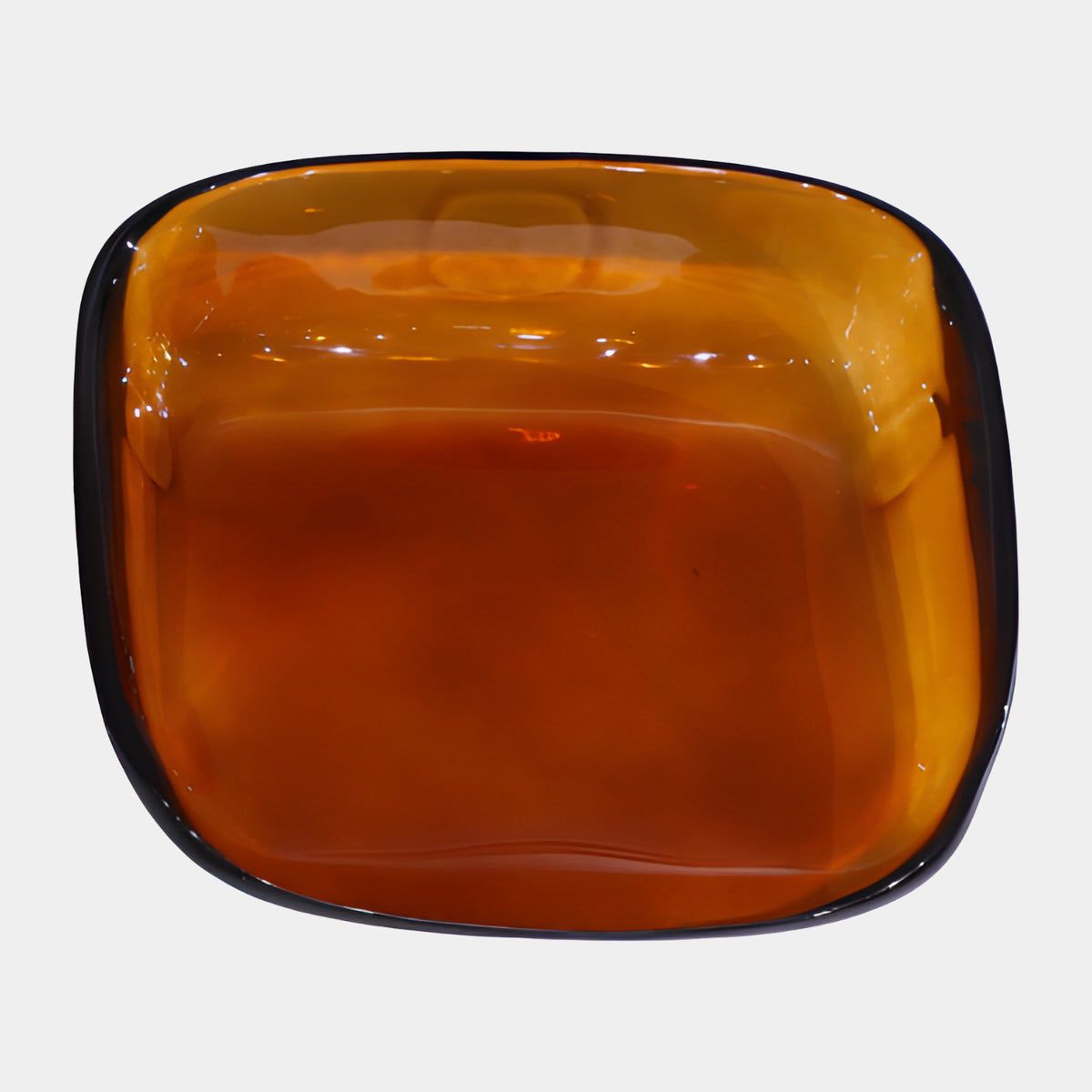Top-down view of the Amber Rounded Square Metal-Rimmed Acrylic Dish, 32cm, with a dark metal rim band, on a plain white background.