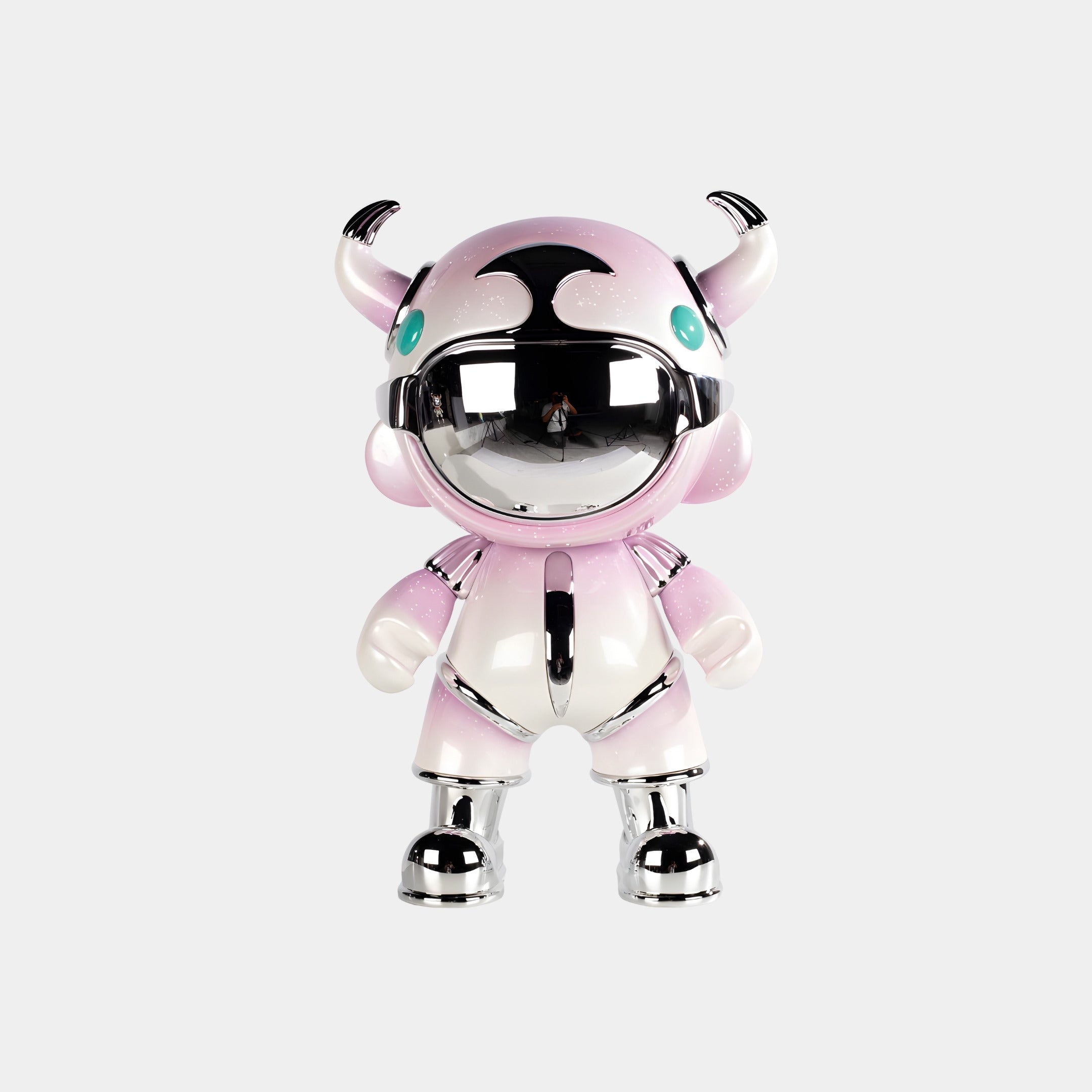 The Blush Pink Suit Astro Devil Figure - 48cm by Giant Sculptures features a shiny blush pink and silver body, green eyes, and small horns—an adorable cartoon-style decorative piece ideal for contemporary spaces.
