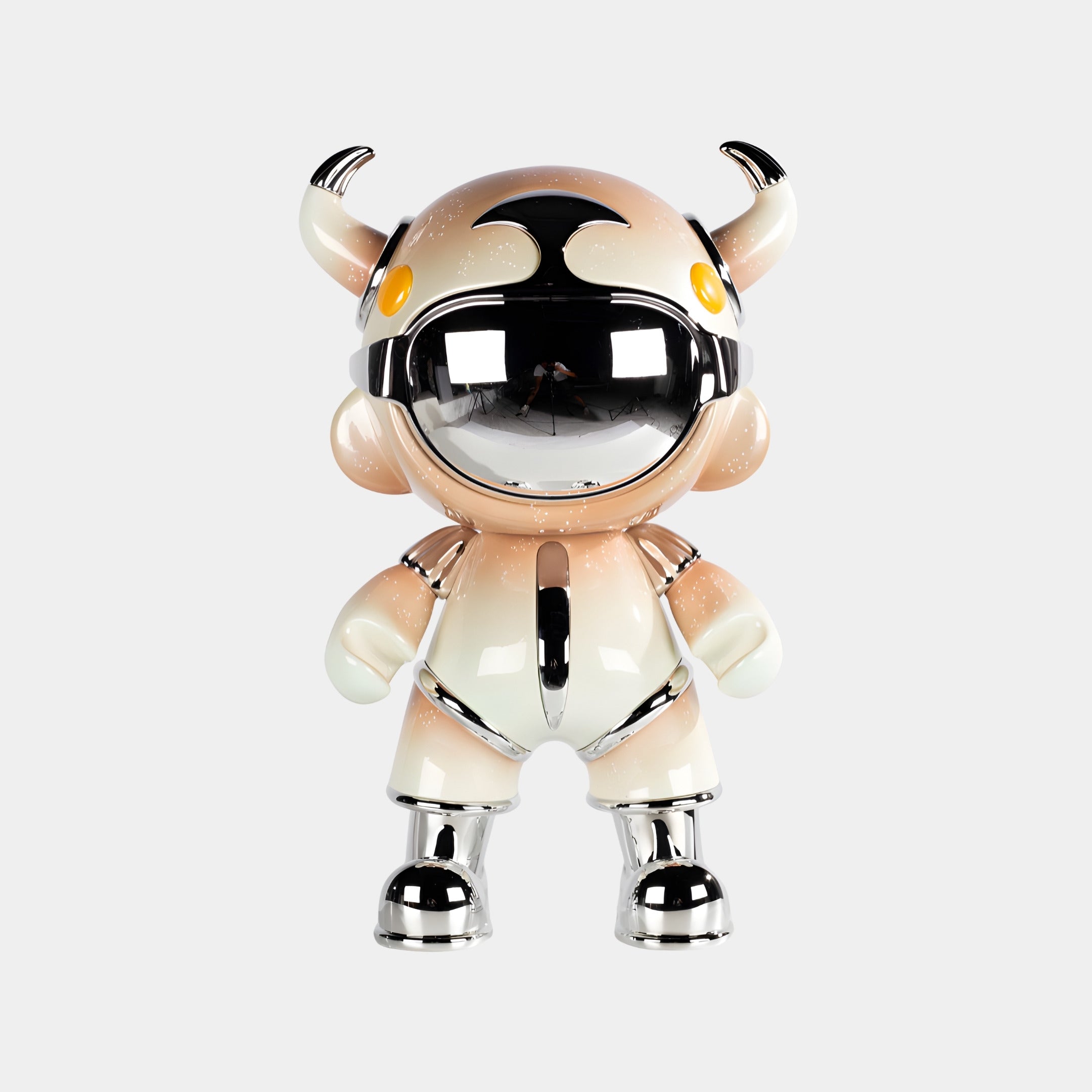 The Champagne Suit Astro Devil Sculpture by Giant Sculptures stands upright, featuring a cartoon-like character with a metallic helmet, mirrored chrome visor, two horns, yellow eyes, and a reflective champagne suit against a plain white background.