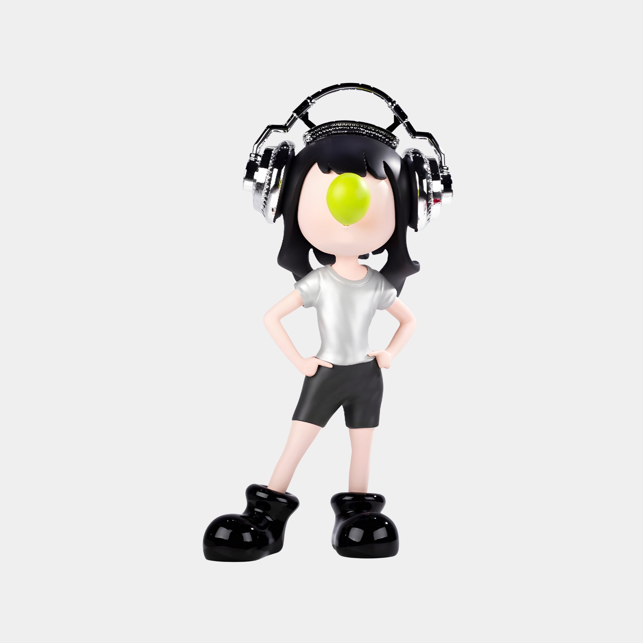 The Lime Pop Vibella Chrome Headset Figure by Giant Sculptures stands 60cm tall, depicting a modern character with black hair, chrome headphones, white shirt, black shorts, oversized black shoes, and a green spot on the stylized face.