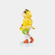 The Sunbeam Yellow Lulabelle Sculpture (60cm) by Giant Sculptures features a joyful girl with long blonde braids, gold bow, yellow top, orange boots, and white-trimmed socks, holding a yellow duck and green-striped bag on a white base.