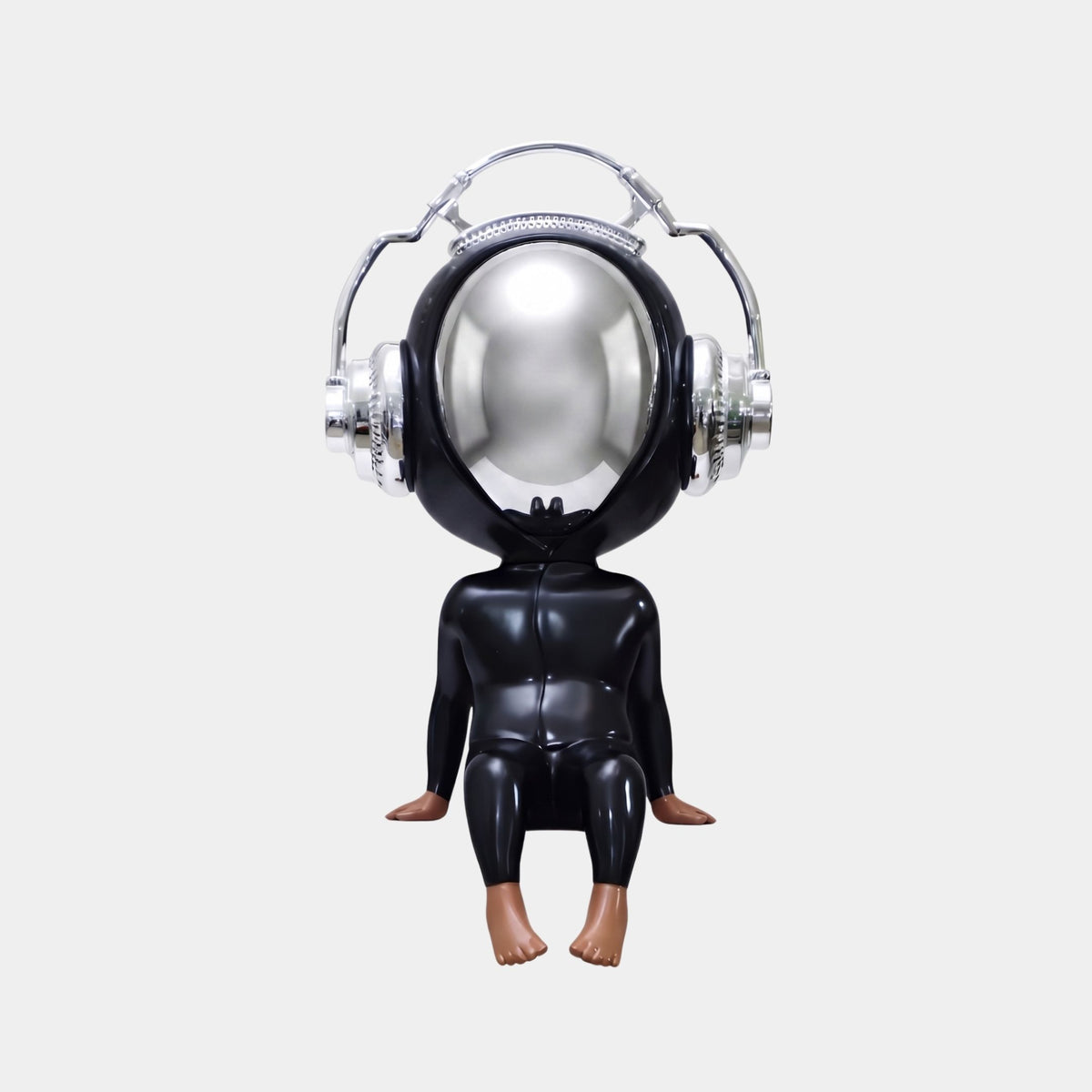 The Midnight Black Alien Beats Figure (55cm) by Giant Sculptures features a futuristic chrome head with silver headphones, black body, and bare feet. This pop art decor piece reflects people and lights for a striking modern touch.
