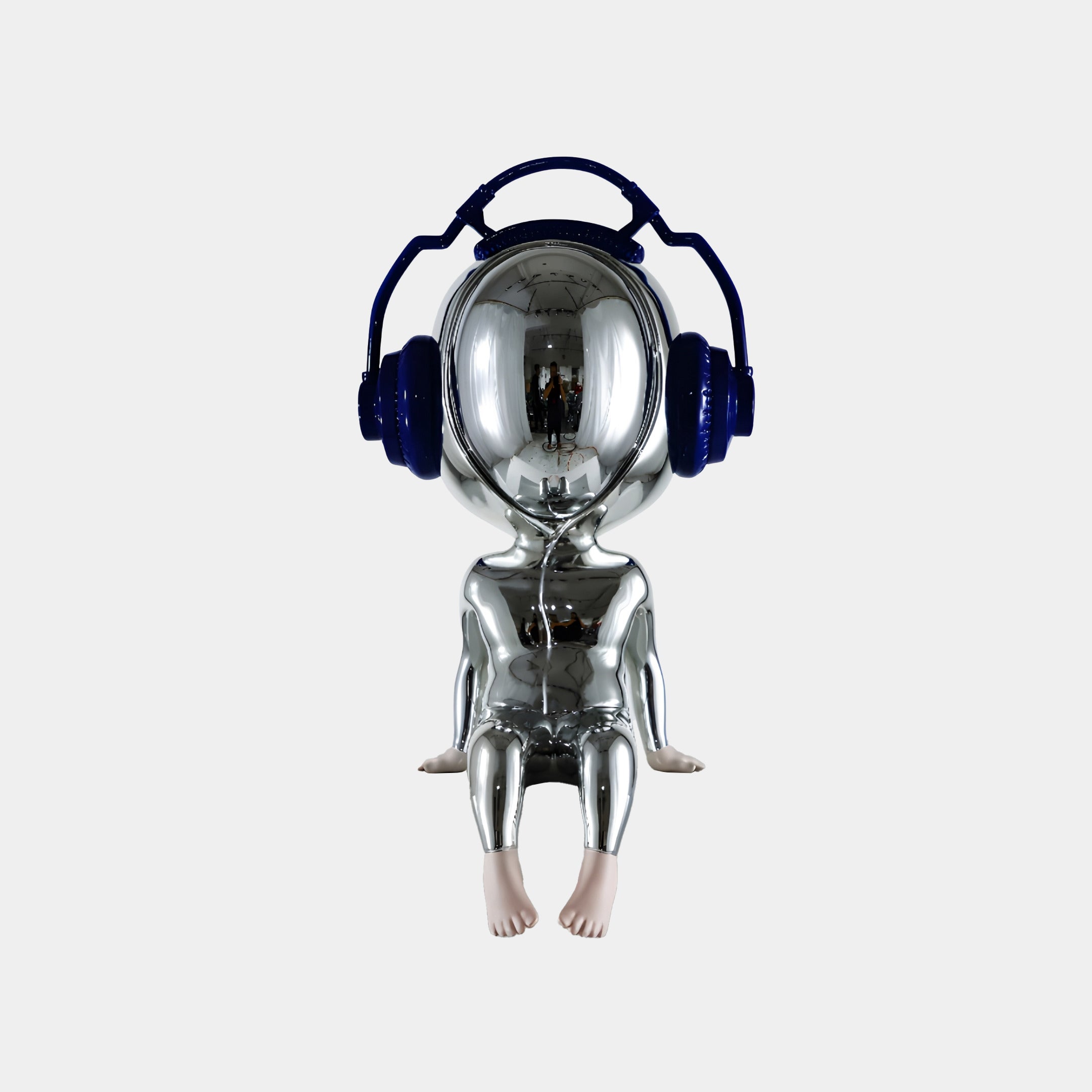 The Giant Sculptures Midnight Chrome Alien Beats Figure - 55cm features a shiny chrome finish, oversized blue headphones, and realistic flesh-toned hands and feet, creating a striking display against a plain white background.