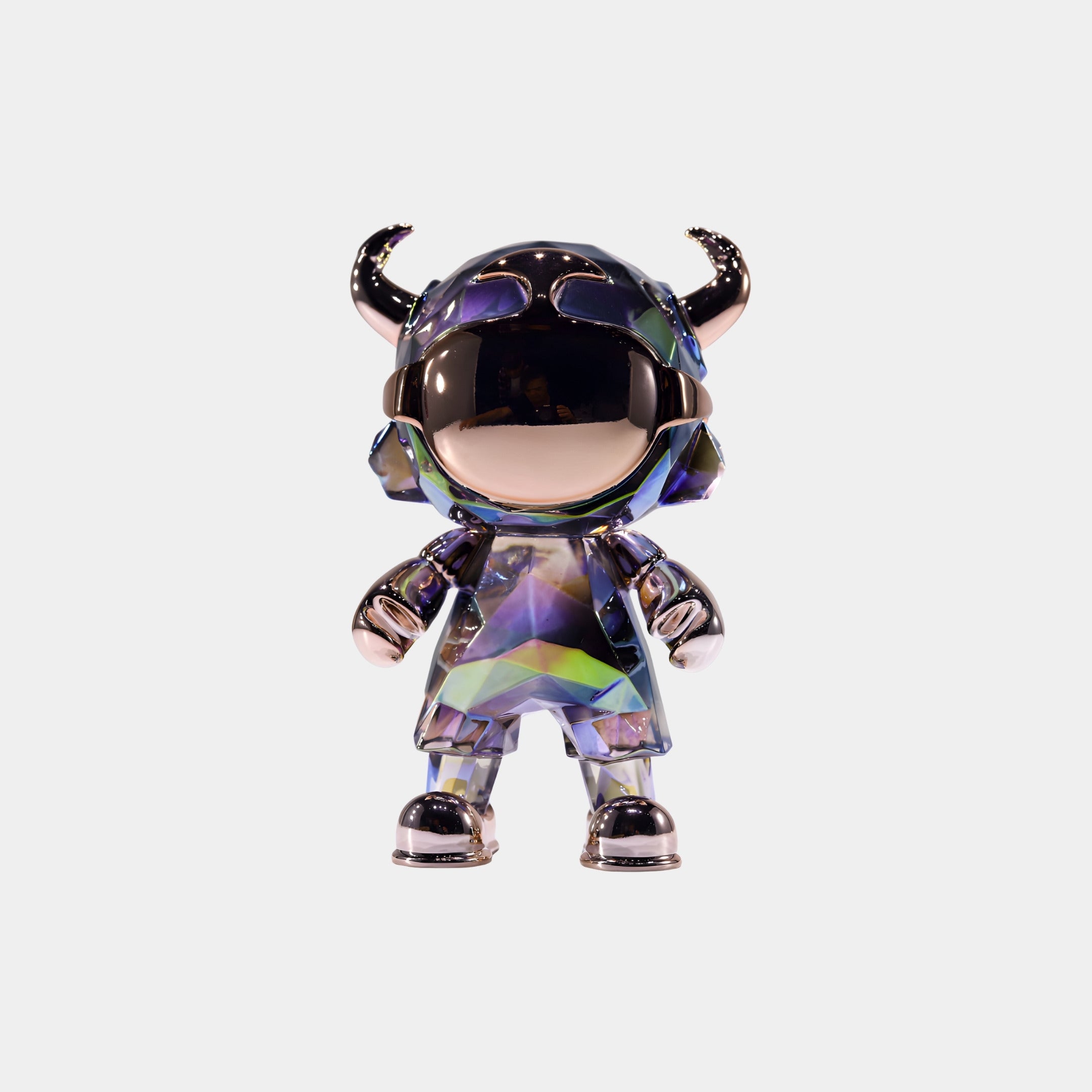 The Midnight Spectrum Astro Devil Figure (15cm) by Giant Sculptures features a faceted, iridescent body, reflective gold details, a round helmet, and small horns, displayed against a plain white background.