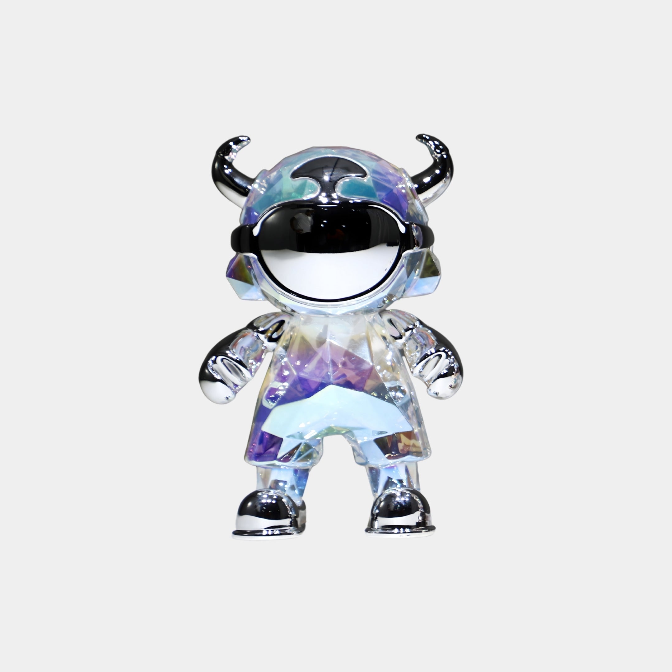 The Chrome Prism Astro Devil Figure (21cm) by Giant Sculptures features a faceted, iridescent chrome body with a horned helmet, large visor, metallic hands, shoes, and accents—displayed on a plain light background.