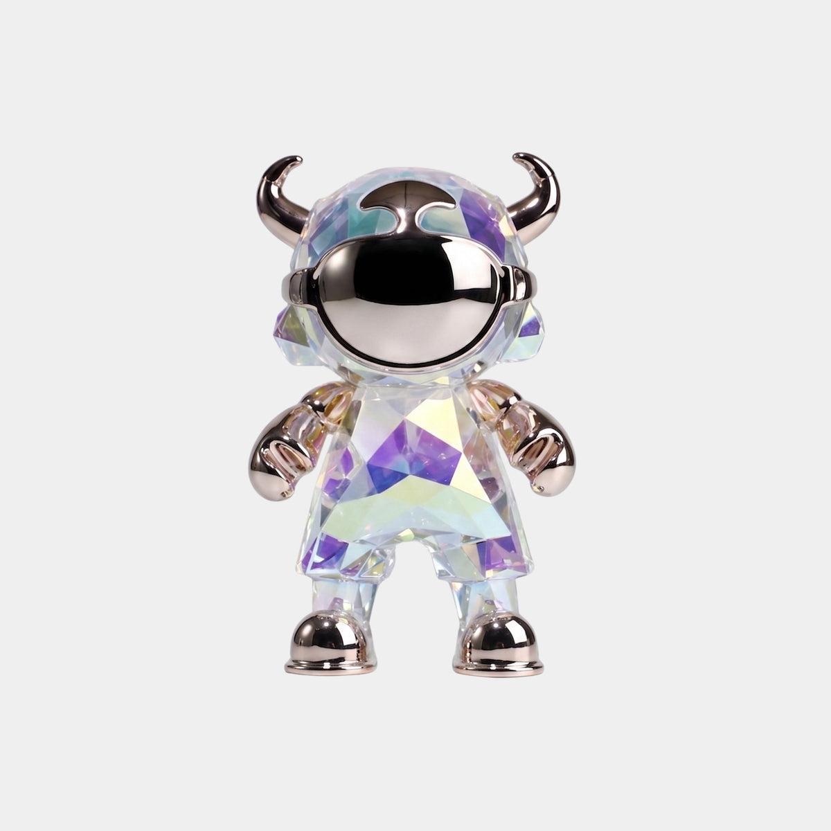 The Aurora Prism Astro Devil Figure (21cm) by Giant Sculptures features an iridescent chrome finish, horned helmet, mirrored visor, and metallic gloves and boots—an eye-catching collectible art toy on a plain light background.