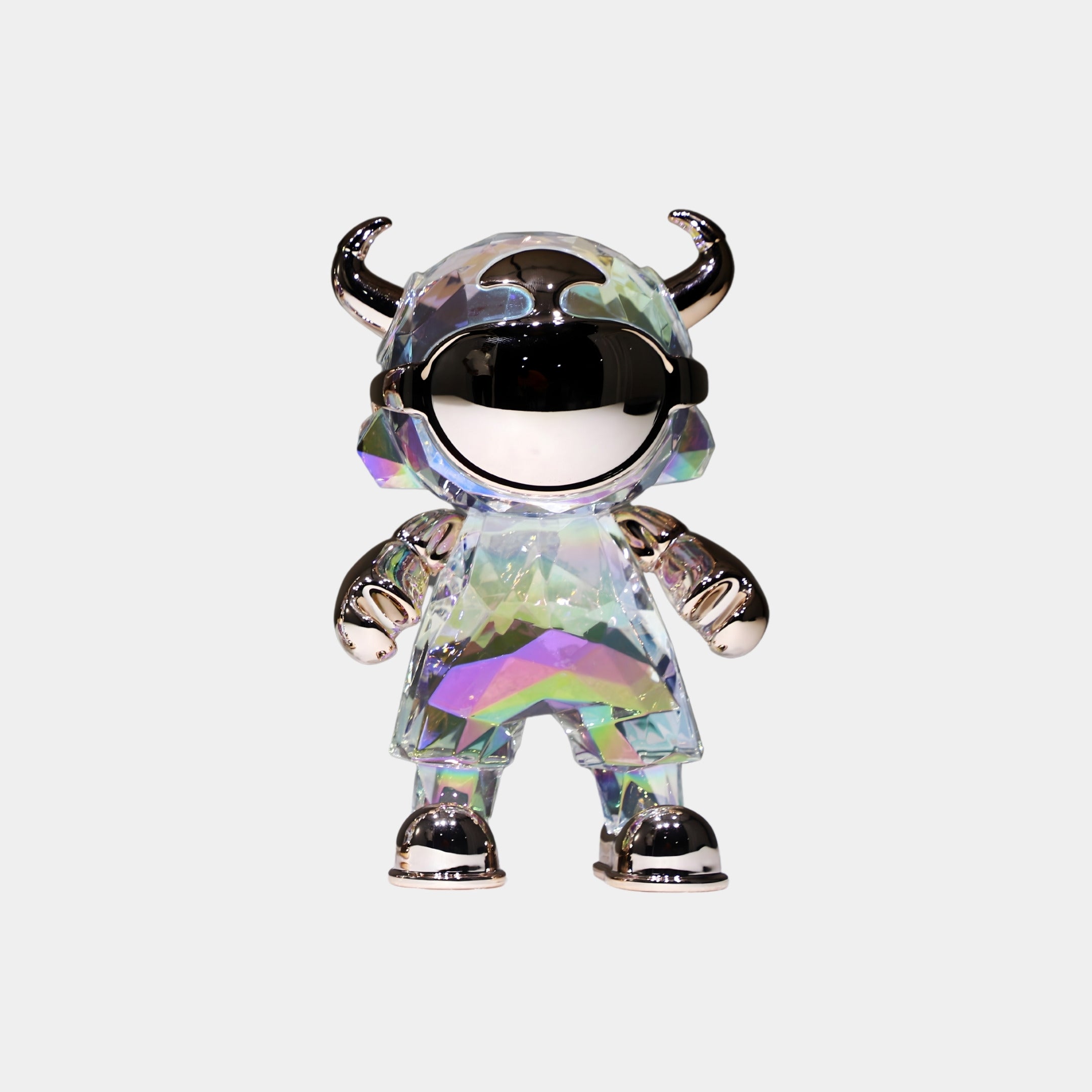 The Spectrum Prism Astro Devil Figure (21cm) by Giant Sculptures features a small, glossy, faceted body with iridescent rainbow colors, a mirrored helmet, silver horns, and metallic accents—a futuristic collectible sculpture.