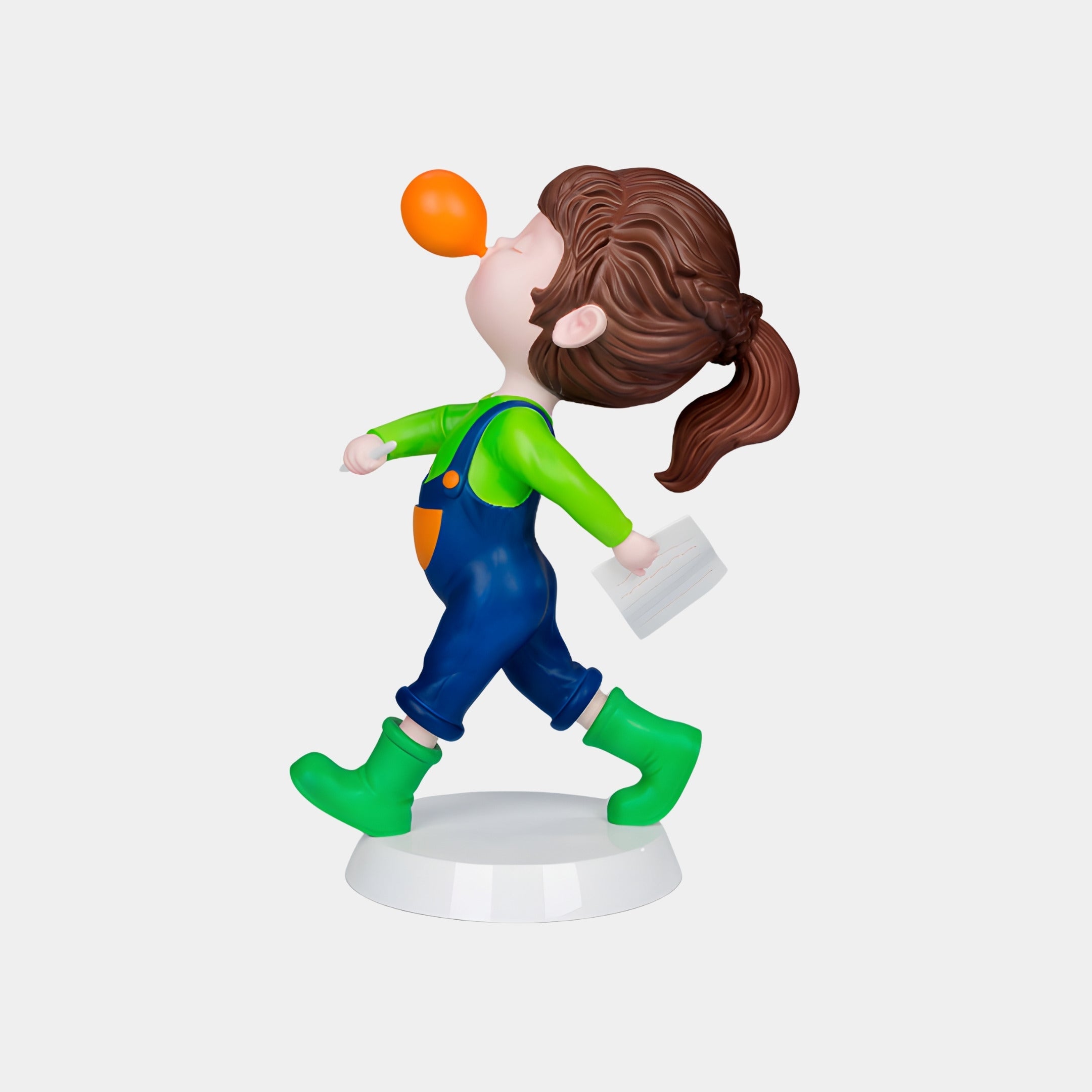 The Giant Sculptures Orange Bubble Popstride Figure - 56cm features a child with brown ponytail, green boots, blue overalls, and a green shirt, walking proudly with an orange bubble on their nose and holding a white rectangular object.