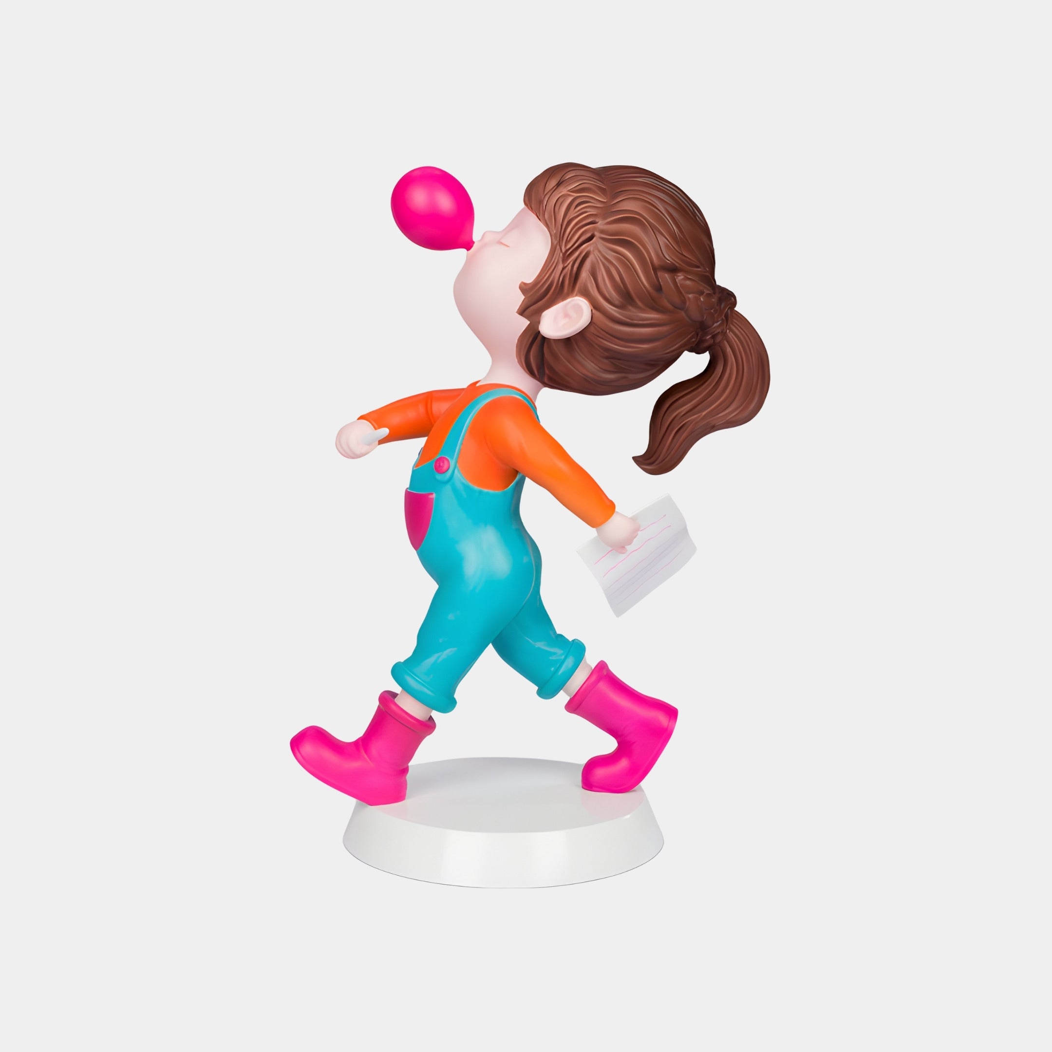 The Pink Bubble Popstride Figure - 56cm by Giant Sculptures features a brown-haired girl in teal overalls and pink boots, confidently walking while blowing bubble gum and holding a white paper—a vibrant pop-art sculpture.