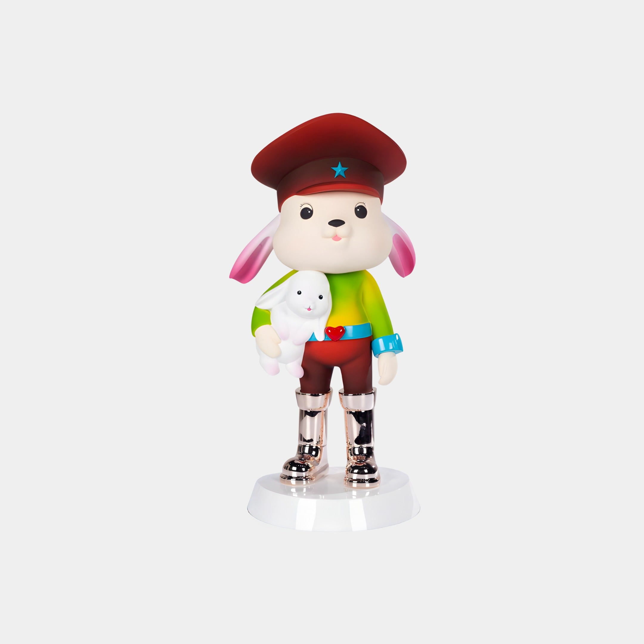 The Carnival Star Bunny Guard Figure by Giant Sculptures stands 55cm tall, featuring a cartoon dog in a red hat with blue star, green shirt, and silver boots holding a white bunny on a white base—a playful decorative accent for your home.