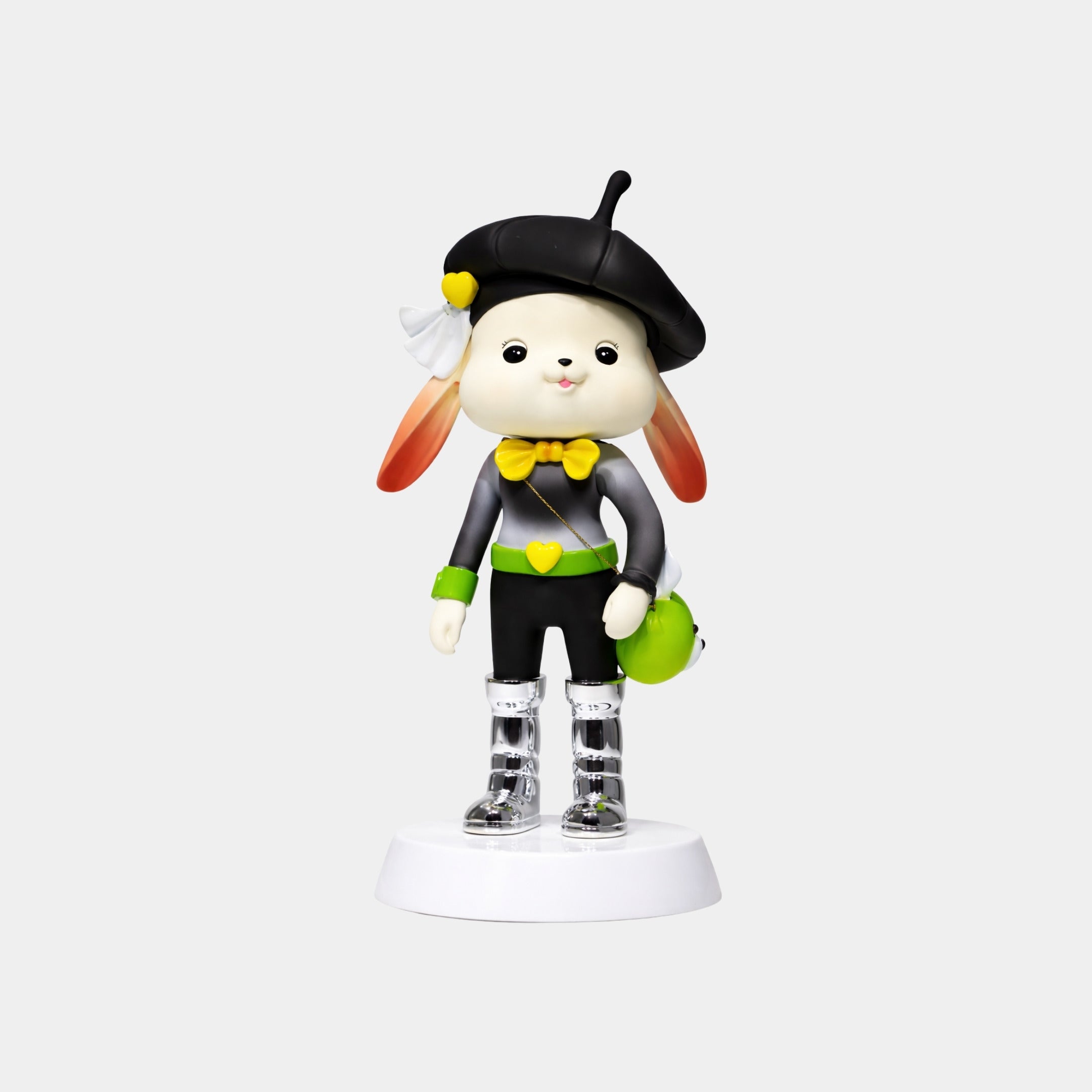 The Giant Sculptures Midnight Lime Bunny Figure - 58cm is a cute designer art toy in a black beret, gray-black outfit with yellow bow tie, clear boots, and green bag, standing on a white base against a plain background.