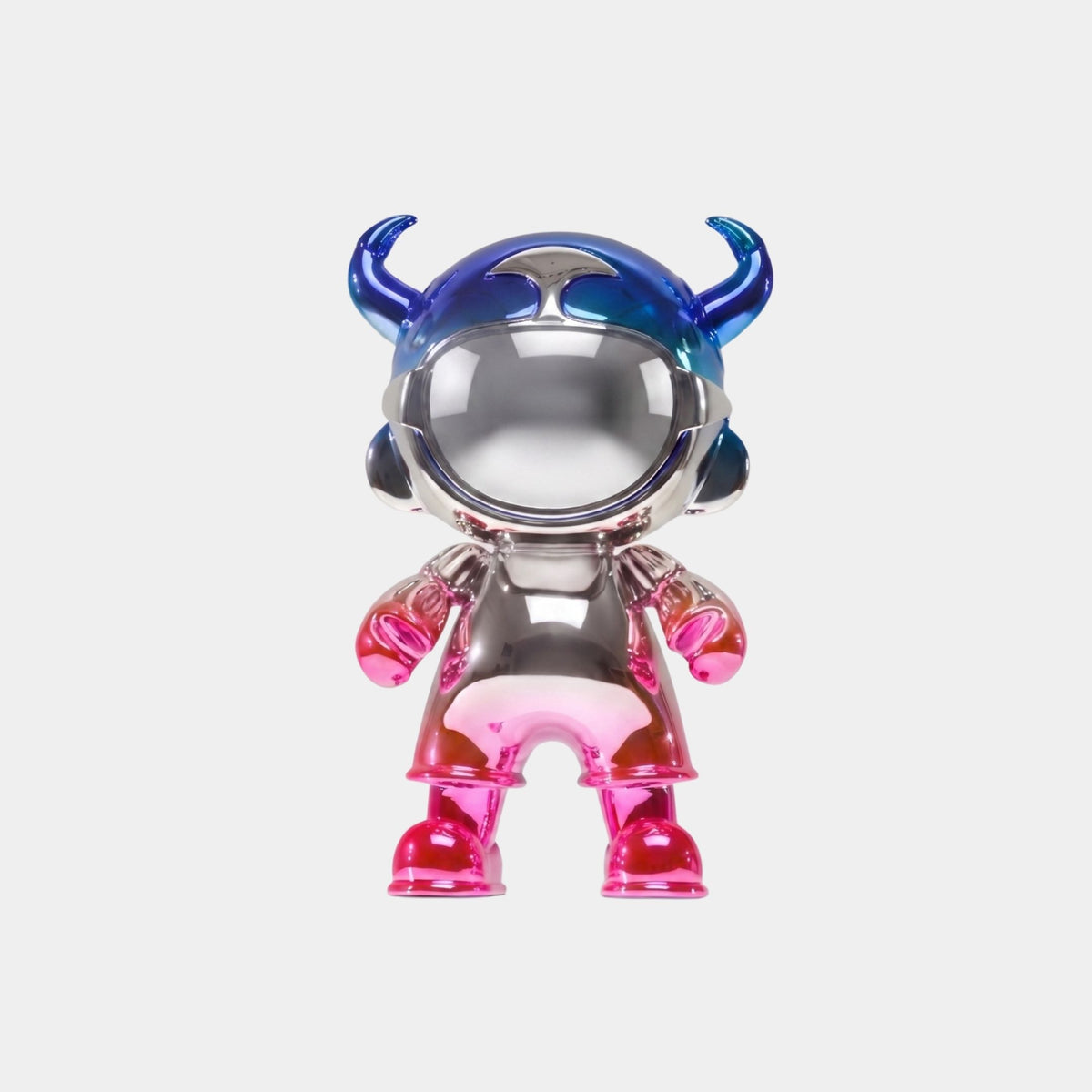 The Giant Sculptures Royal Blue & Pink Electroplated Astro Devil Figure (35cm) features a shiny metallic finish, large mirrored visor, blue horned helmet, and pink arms and legs, displayed against a plain white background.