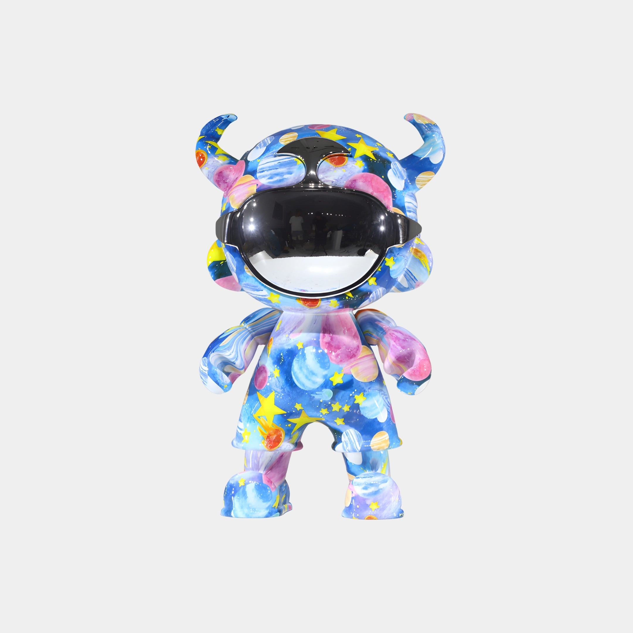 The Galaxy Orbit Astro Devil Figure - 35cm by Giant Sculptures features horns, a shiny black visor, and a blue galaxy-themed surface with stars, planets, and nebulae, making it a striking display piece against a white background.