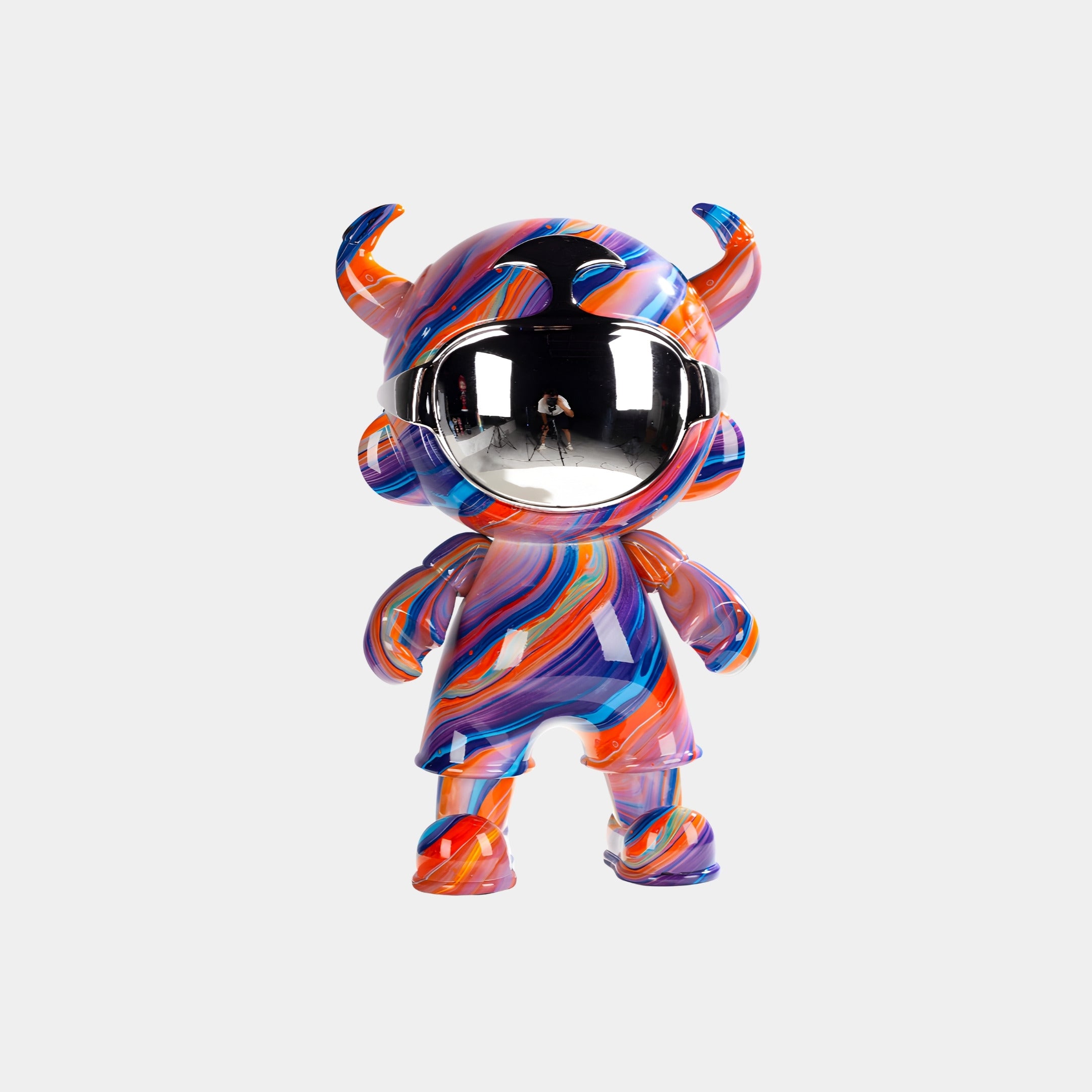 The Solar Burst Astro Devil Figure - 35cm by Giant Sculptures features a vibrant mix of orange, purple, and blue swirls, small horns, and a reflective faceplate—making this collectible art toy truly eye-catching.
