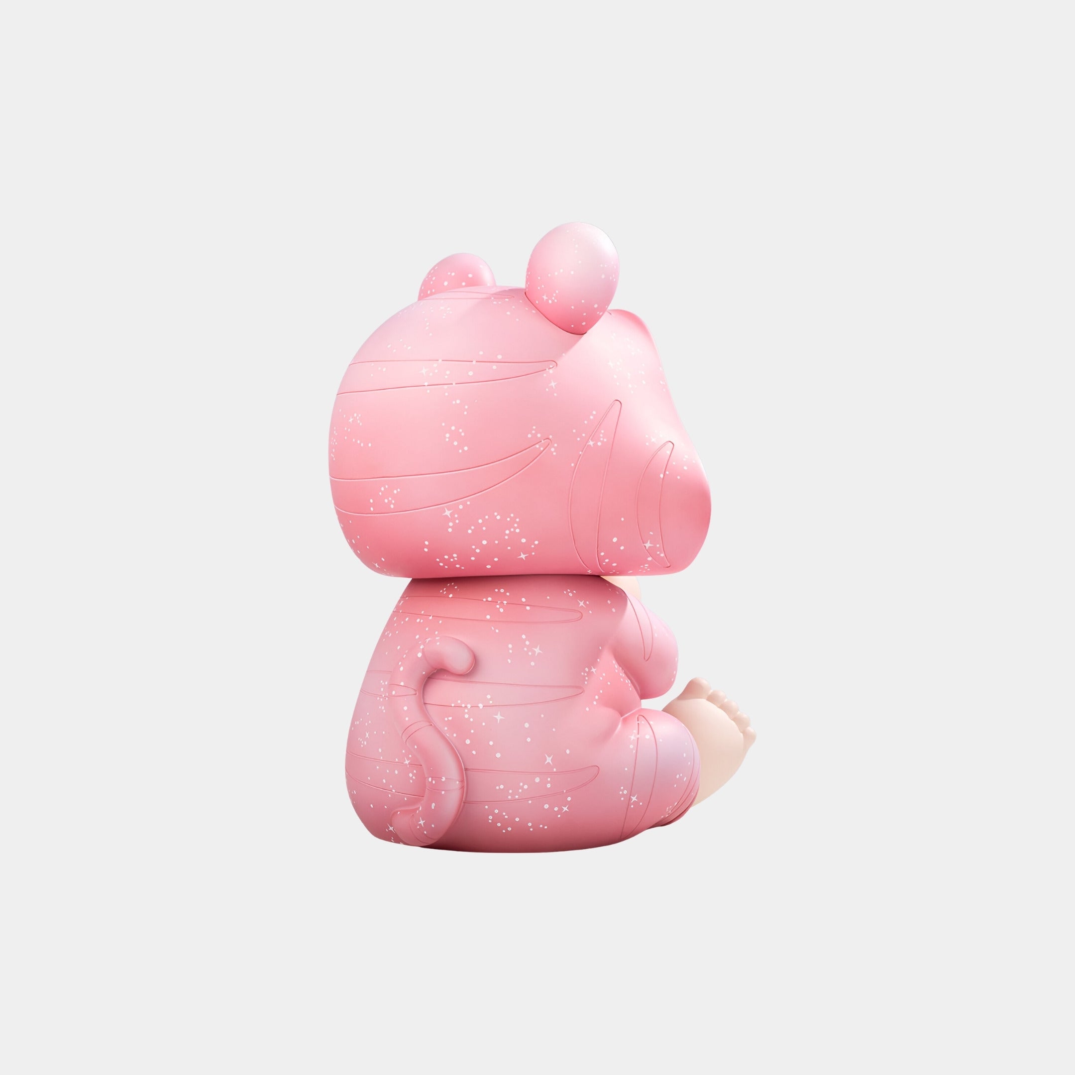 The Pink Stardust Baby Dreamer Figure - 30cm by Giant Sculptures is a collectible art toy pig with a curled tail and white speckles, perfect for celestial nursery décor on soft, light backgrounds.