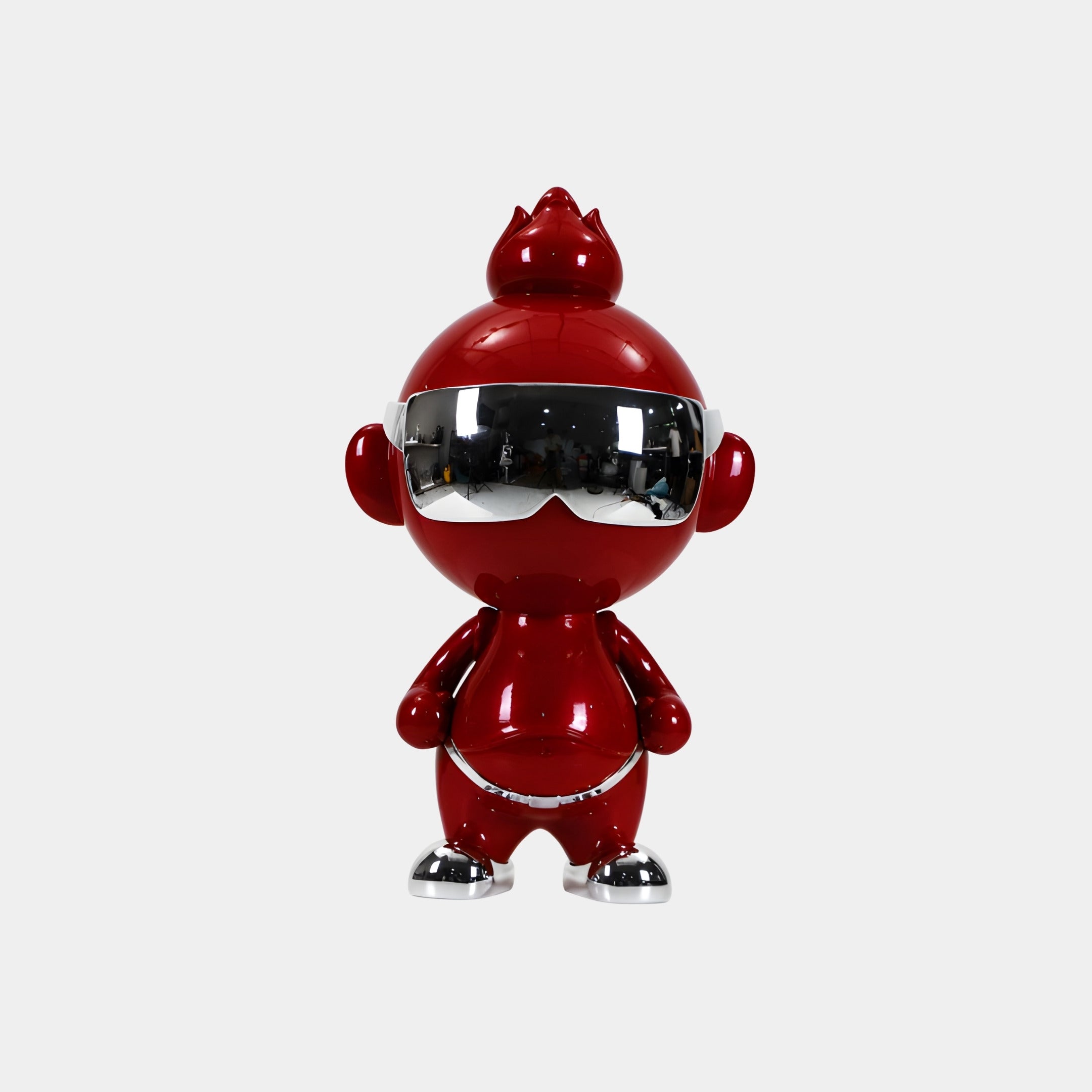 The Crimson Chrome Orbix Figure by Giant Sculptures stands upright at 48cm, featuring a shiny red chrome finish, large head, silver sunglasses and shoes—an ideal designer art toy for stylish modern decor.