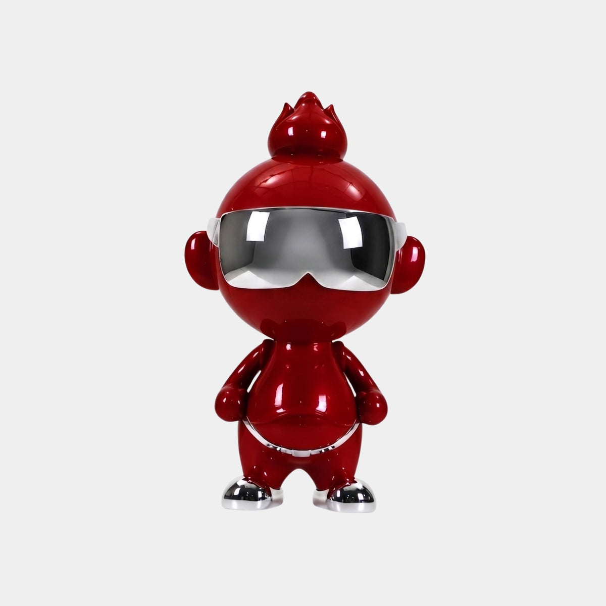 The Crimson Chrome Orbix Figure by Giant Sculptures stands upright at 48cm, featuring a shiny red chrome finish, large head, silver sunglasses and shoes—an ideal designer art toy for stylish modern decor.