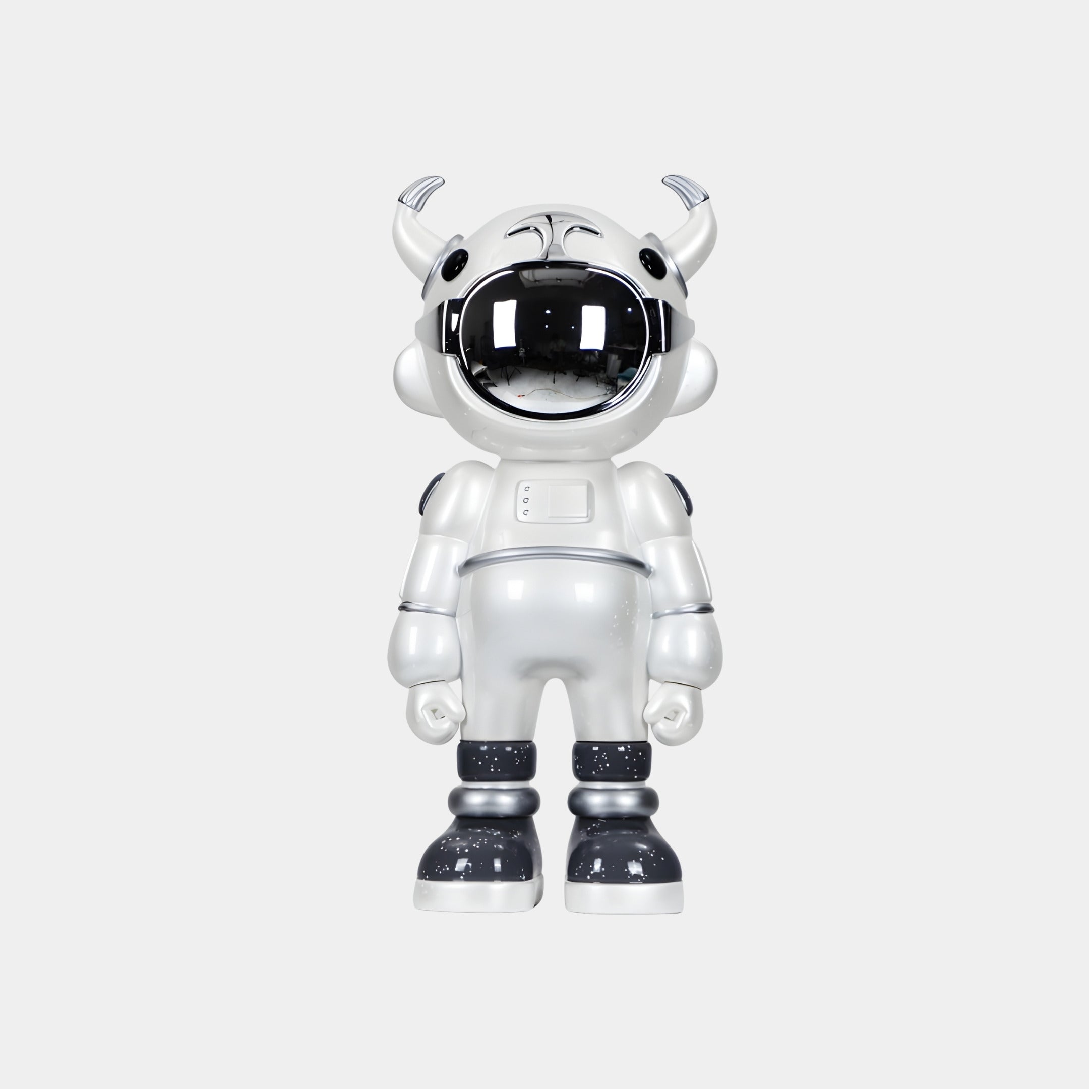 The Giant Sculptures Arctic White Astro Robot Figure - 48cm stands upright with a large black visor, small horns, and black-and-white boots, resembling a sci-fi sculpture against a plain light gray background.