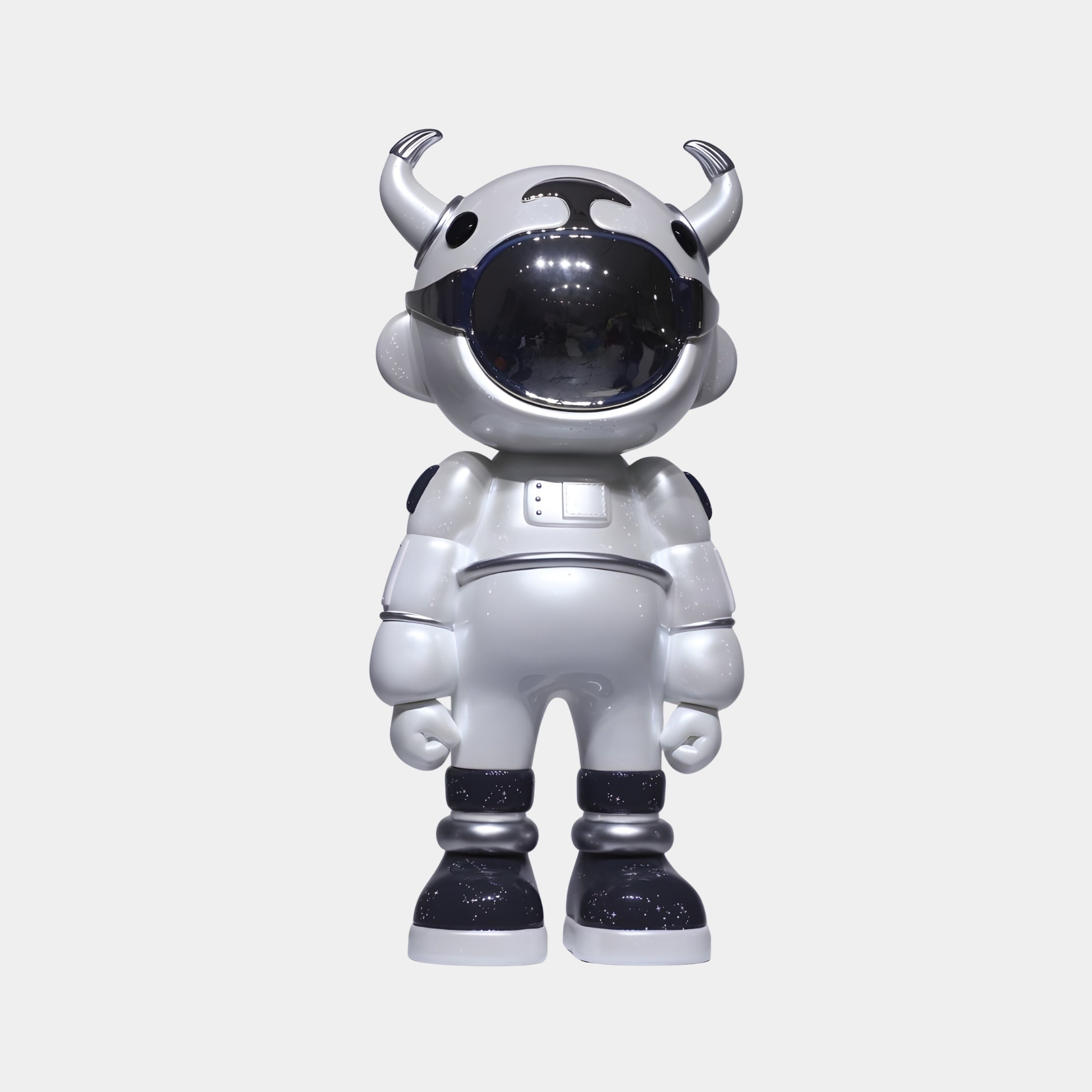 The Chrome Astro Robot Sculpture (70cm) by Giant Sculptures is a designer art toy figure blending cow and astronaut features, with a pearlescent white suit, black accents, shiny visor, and helmet horns, standing upright against a white background.