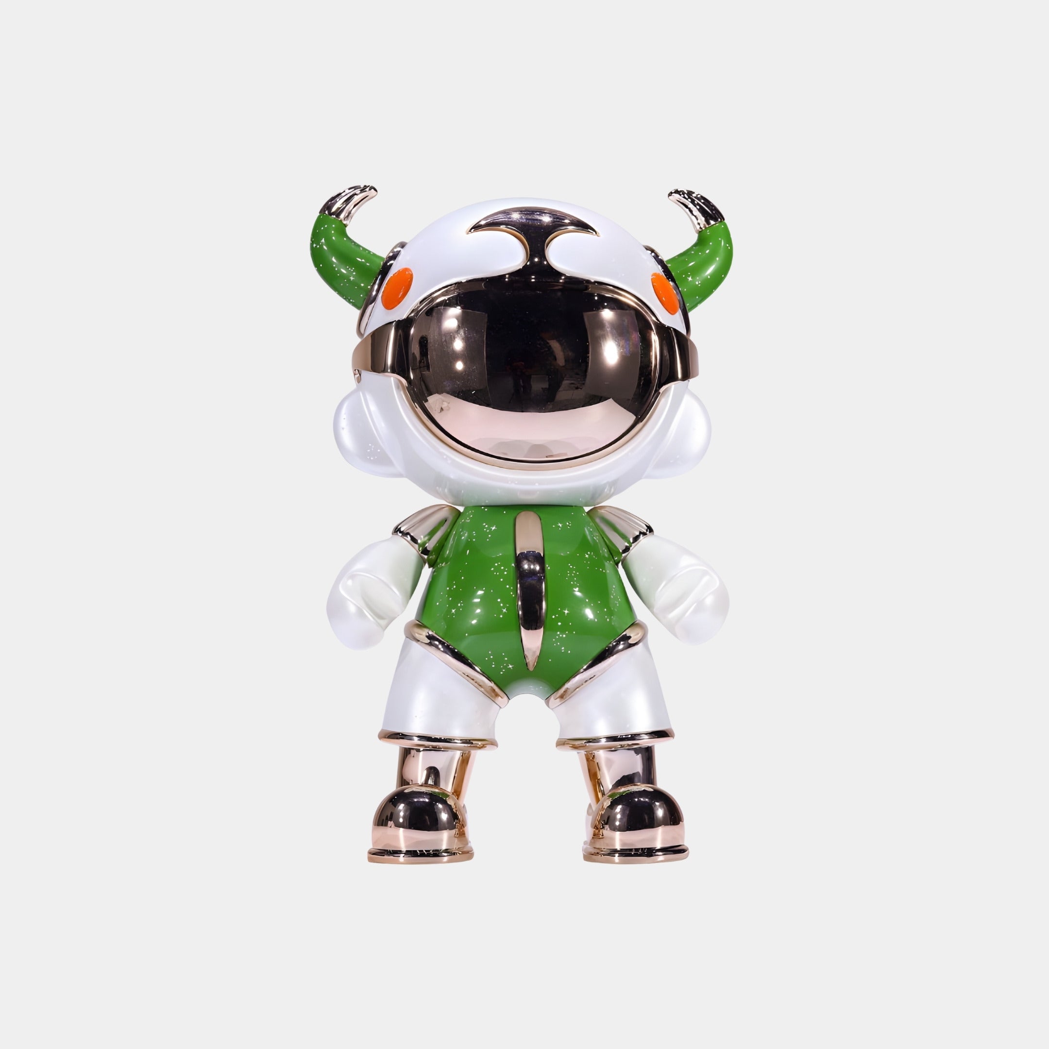 The Giant Sculptures Green & White Suit Astro Devil Figure (31cm) is a collectible sculpture with a metallic helmet, horn-like protrusions, orange eyes, and metallic accents, crafted from eco-friendly resin.