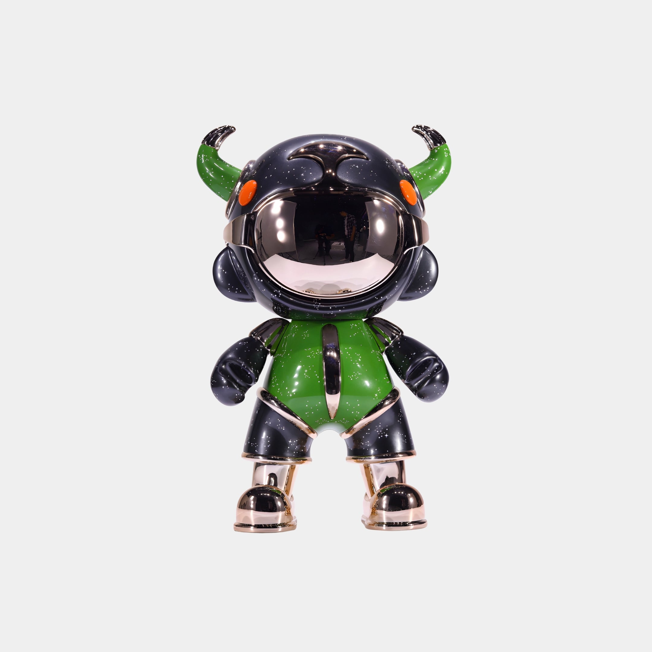 The Green & Black Suit Astro Devil Figure - 31cm by Giant Sculptures features a shiny black helmet with green horns, orange eyes, and gold accents, crafted from eco-friendly resin and shown against a plain white background.