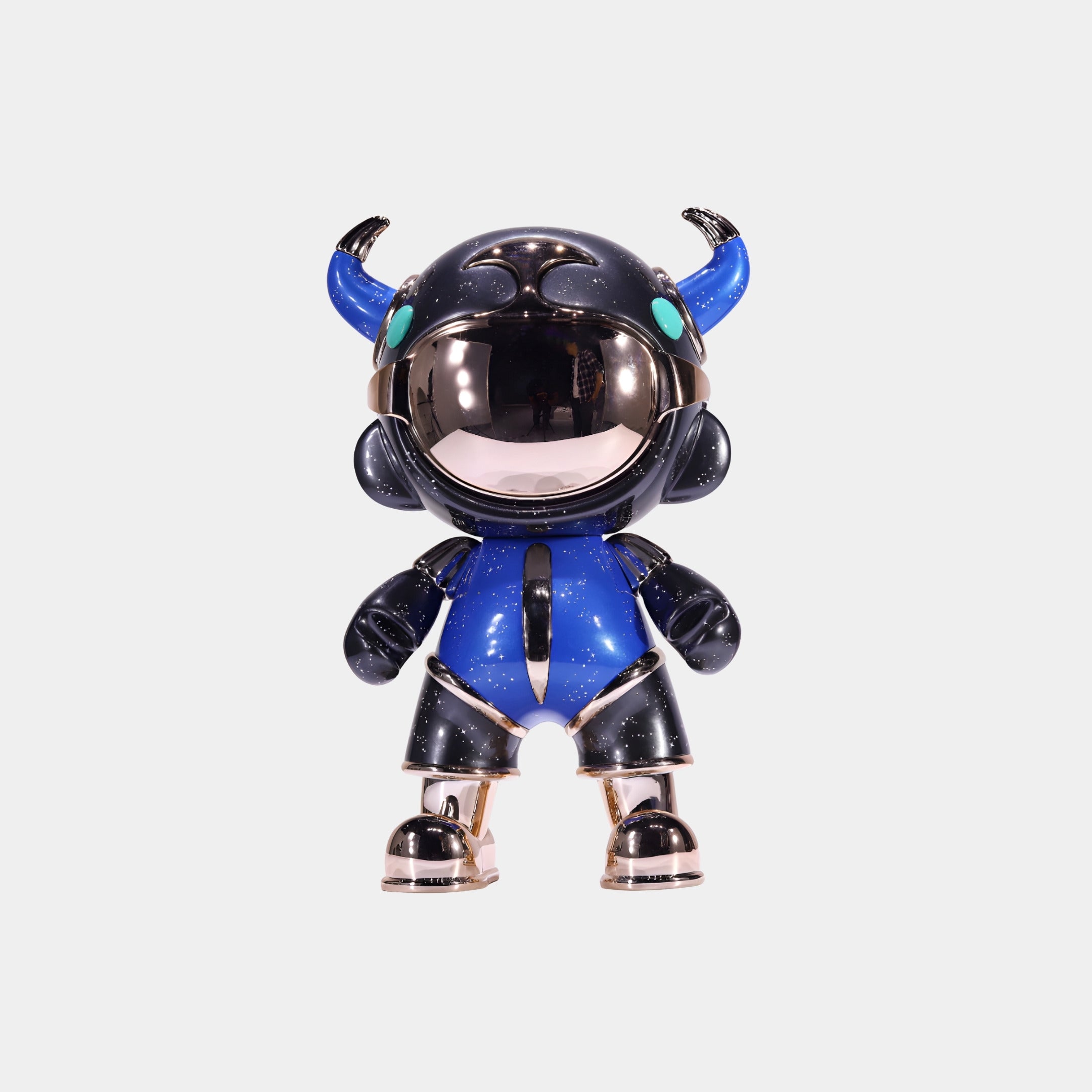 The Blue & Black Suit Astro Devil Figure by Giant Sculptures stands 31cm tall, featuring a horned astronaut in a shiny black and blue suit with teal horns and a reflective helmet. This collectible resin sculpture blends space and devilish design.