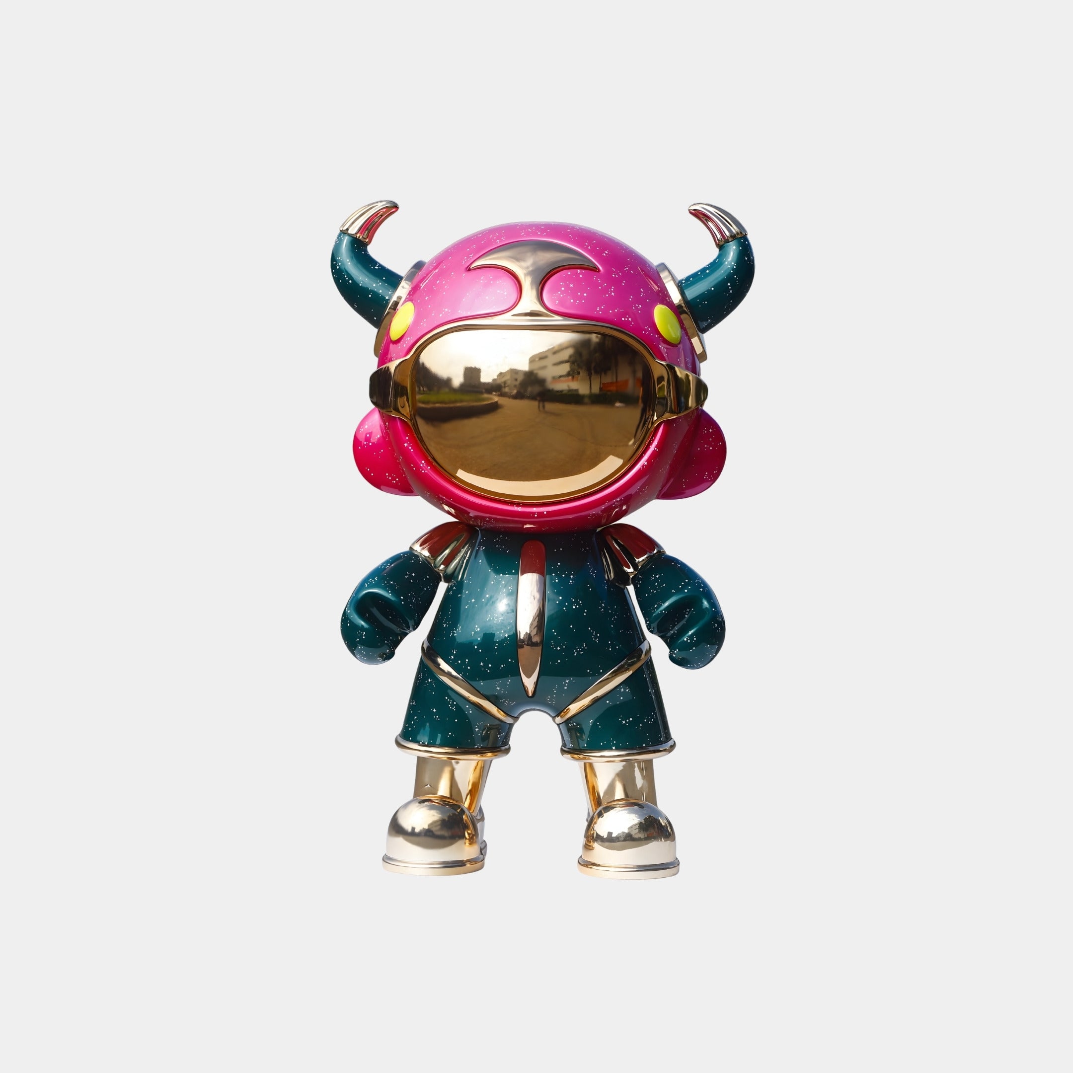 The Giant Sculptures Pink & Teal Suit Astro Devil Figure - 31cm features a pink and purple horned helmet, gold visor, green and gold suit, and gold boots, displayed against a plain white background.