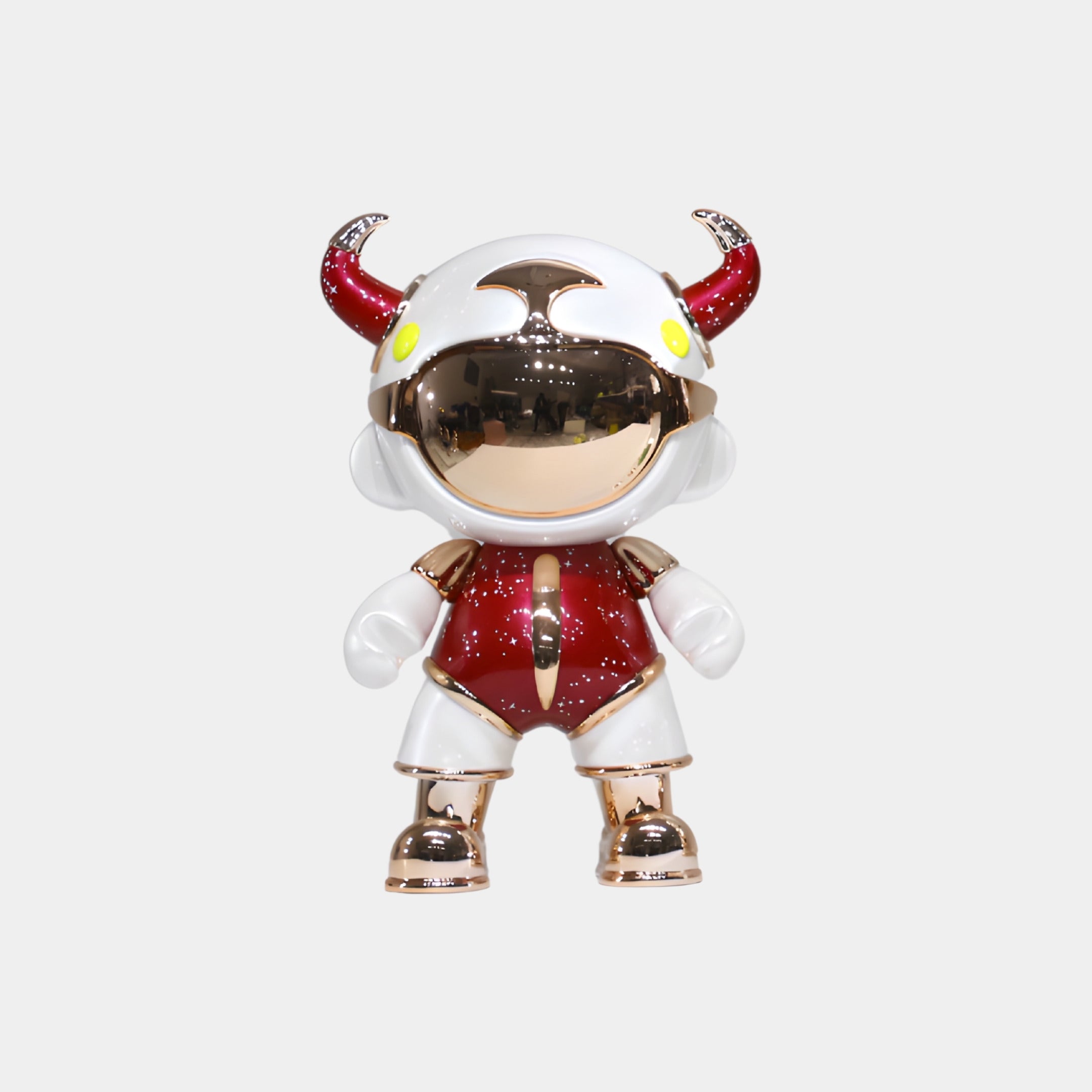 The Giant Sculptures Red & White Suit Astro Devil Figure (31cm) features a mirrored visor, white helmet with red horns, and a metallic red and white suit with gold accents, crafted from eco-friendly resin against a plain white background.