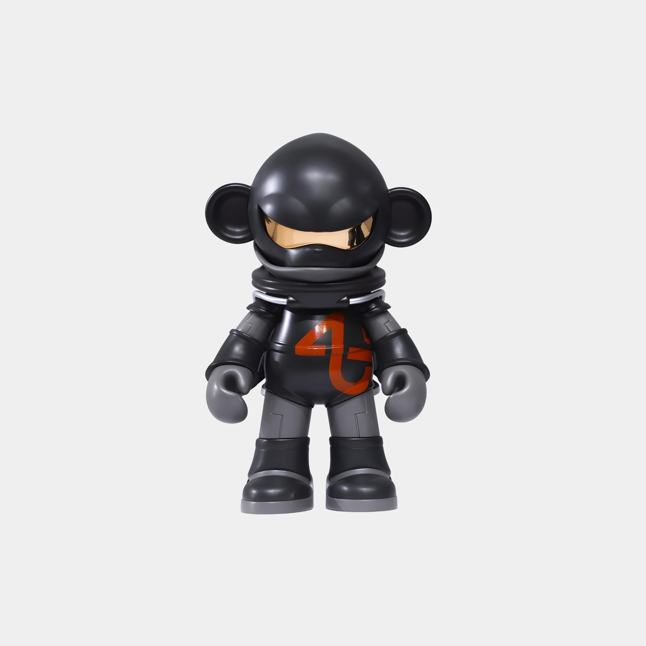 The Phantom Black Cosmo Ape Figure - 25cm by Giant Sculptures is a collectible resin statue of a black ape in a futuristic spacesuit with an orange chest design and shiny gold visor, posed against a plain white background.