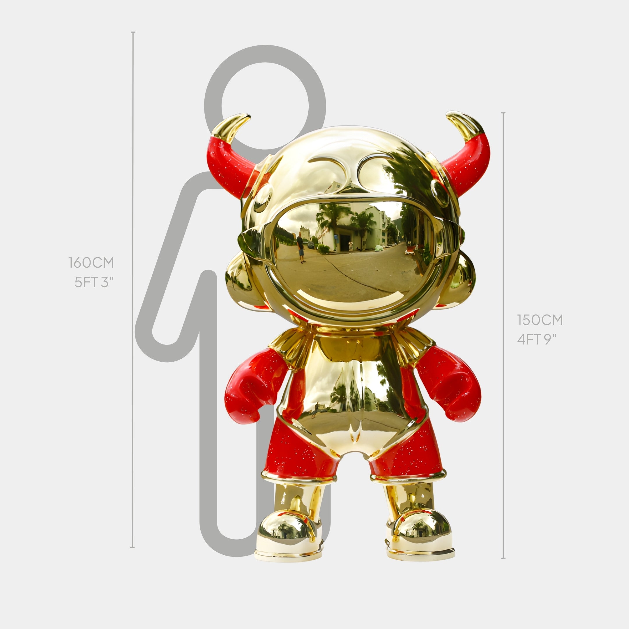 The Giant Sculptures Gold & Red Suit Astro Devil Sculpture - 150cm, made of electroplated fiberglass with red horns, gloves, and shorts, stands before a height chart beside a person's outline for scale.