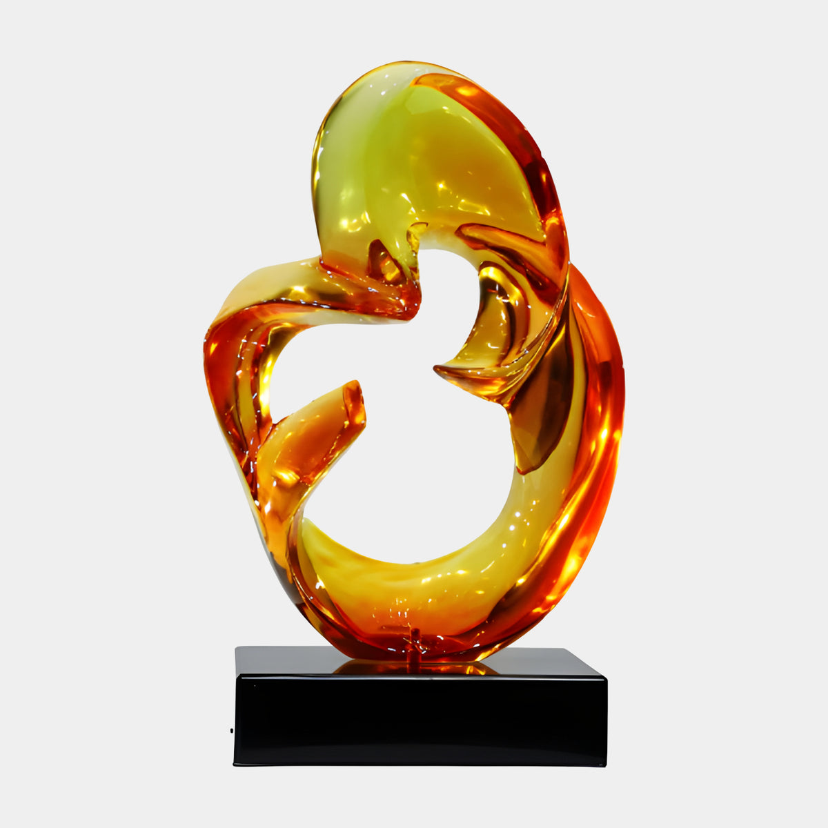 Amber & Yellow Closed Loop Resin Sculpture, 50cm, a swirling loop with two arms crossing near the top, set on a black marble base, shown against a plain white background.