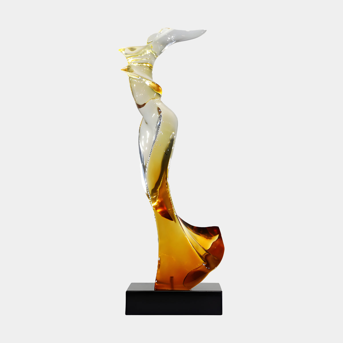 Amber to Clear Windblown Figure Resin Sculpture, 77cm, swept flowing form shading from amber at the base to clear at the top, on a black marble block, plain light background.