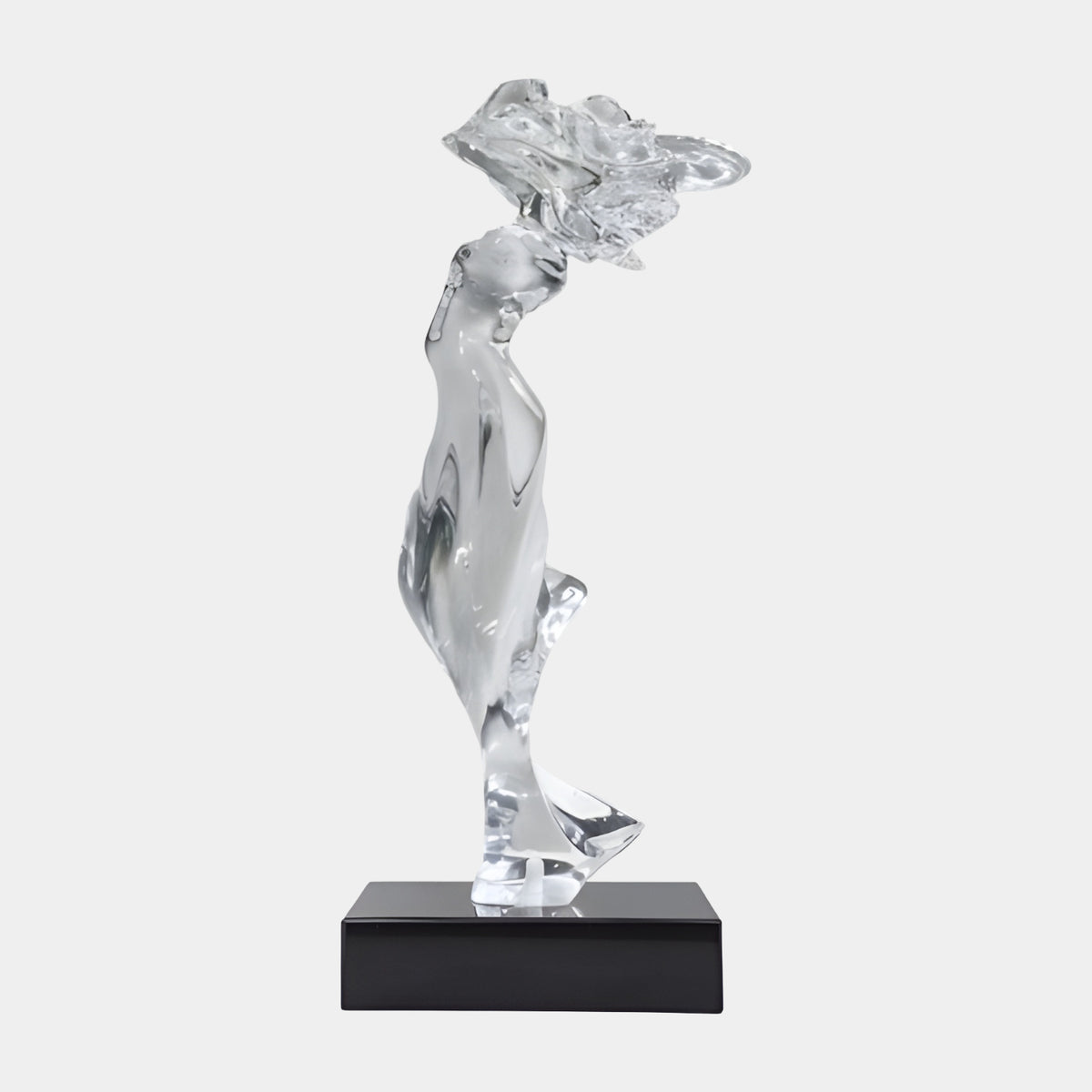 Clear Slender Windblown Figure Resin Sculpture, 62cm, glassy figure leaning forward with tossed crest, on black stone base, plain white background.